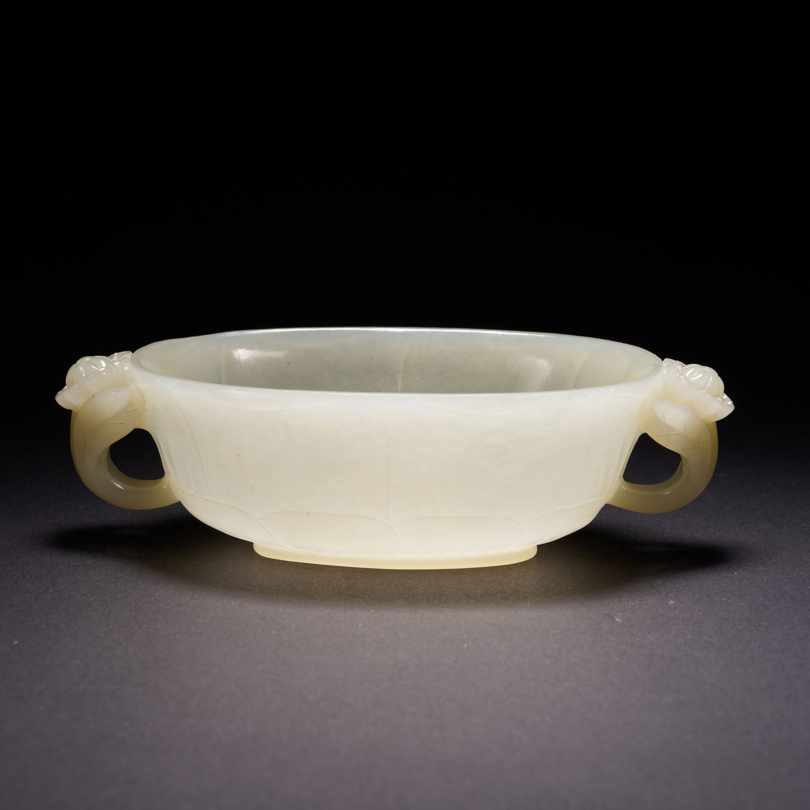 A HETIAN JADE OVAL VESSEL WITH LOTUS-SHAPED HANDLES AND PLAYFUL DECORATION, QING DYNASTY (1 of 7)
