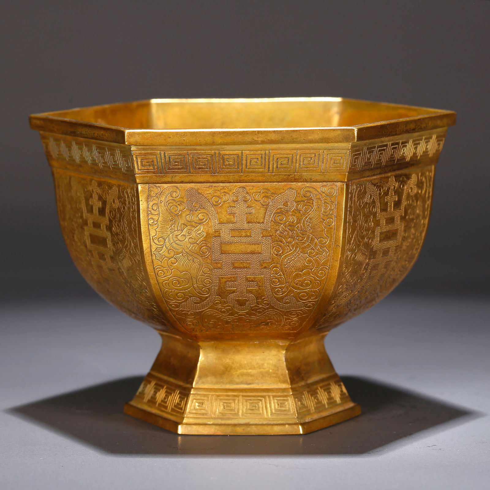 A GILT BRONZE CUP WITH BLESSING AND LONGEVITY PATTERN: Gilt bronze cup with blessing and longevity pattern