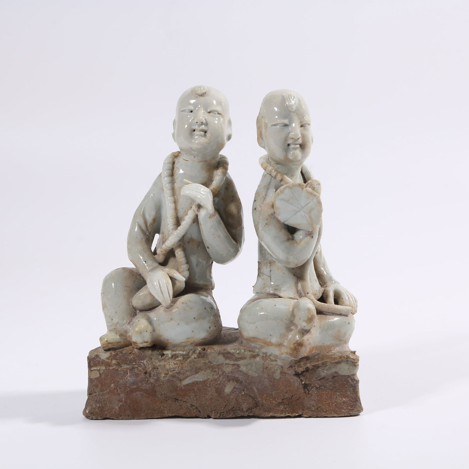 A SONG DYNASTY YINGQING GLAZE HARMONIOUS IMMORTALS FIGURINE (1 of 8)