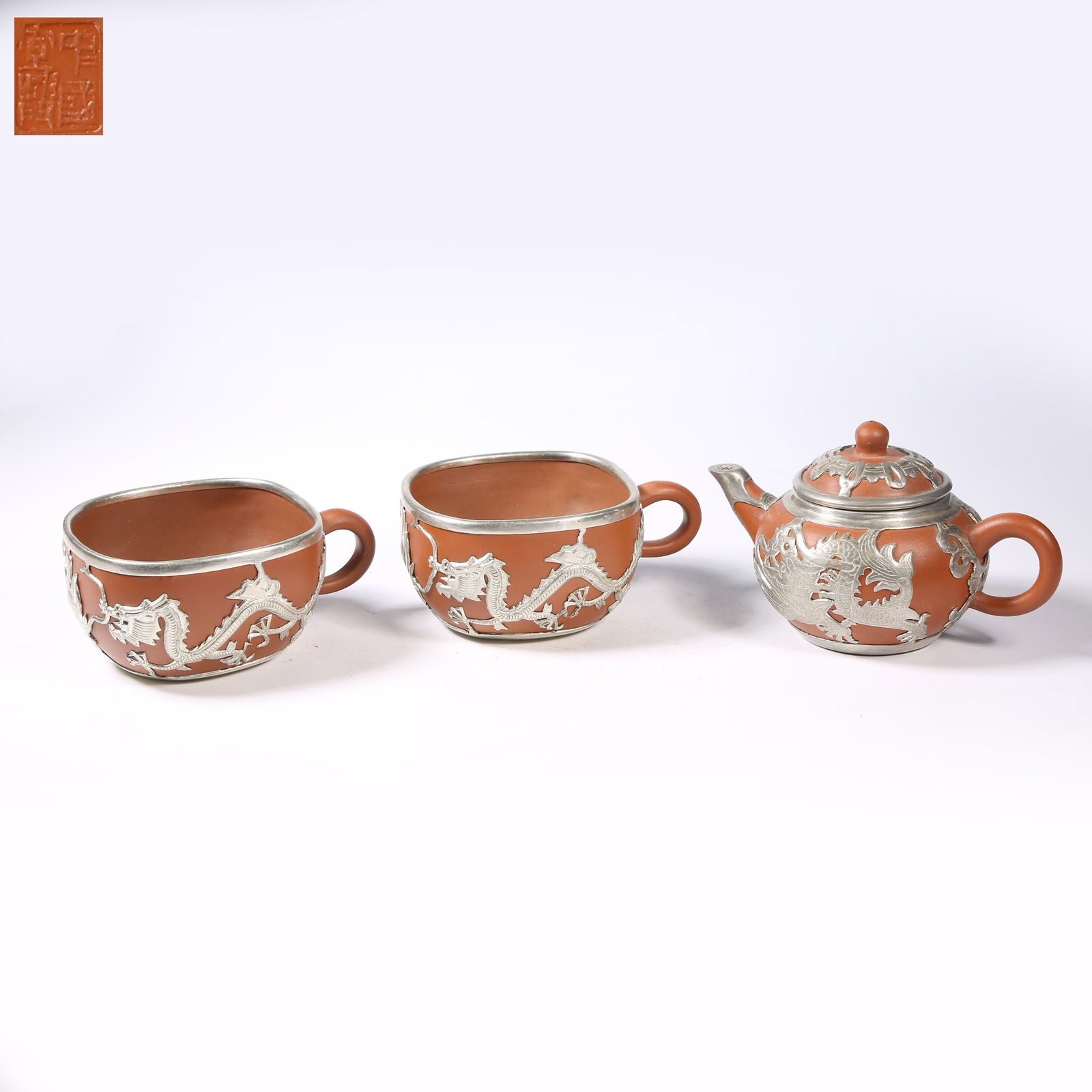 A SET OF TIN-WRAPPED ZISHA TEAPOTS (1 of 10)
