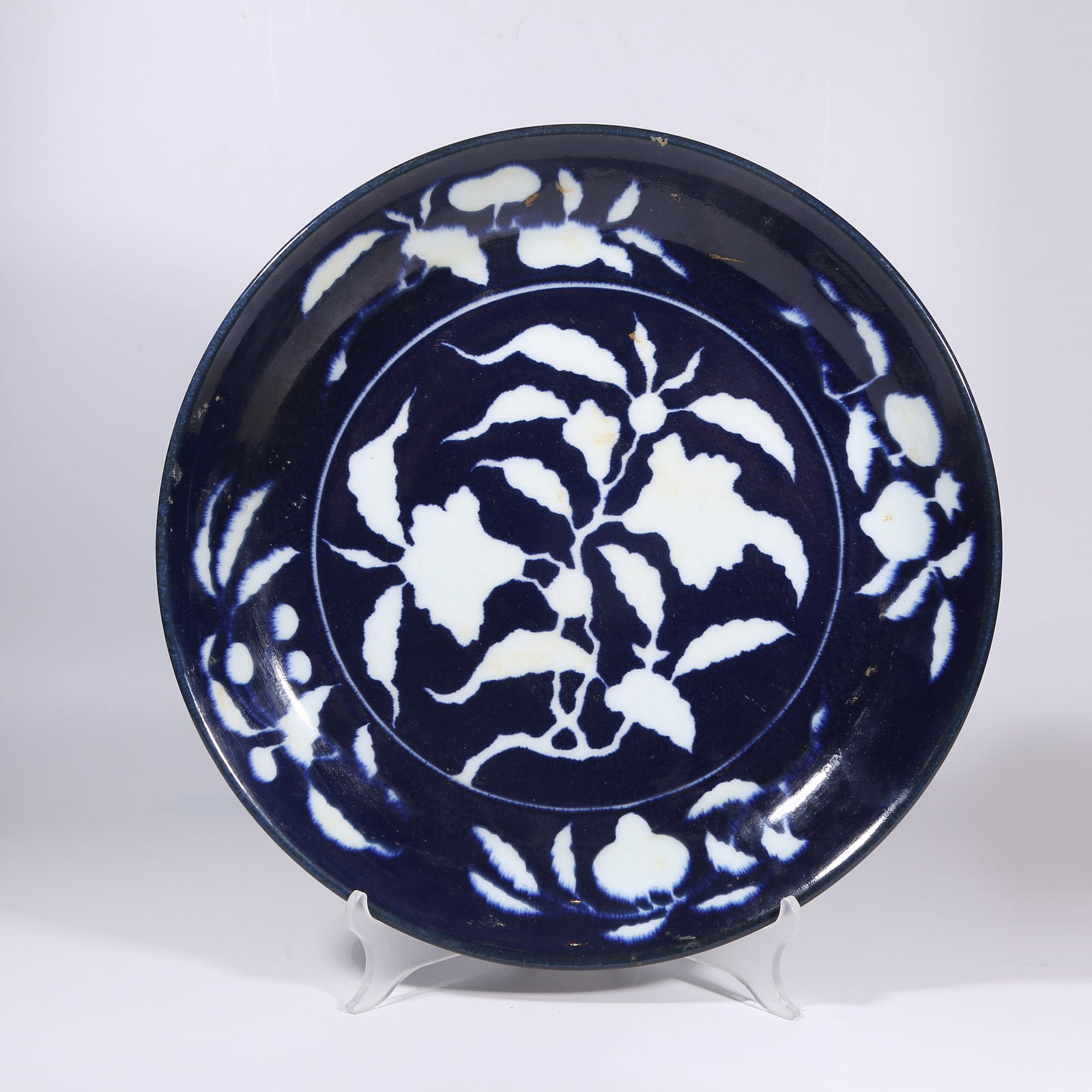 A SACRIFICIAL-BLUE GLAZE PLATE WITH RESERVED PAPER-CUT FLORAL MOTIFS (1 of 10)