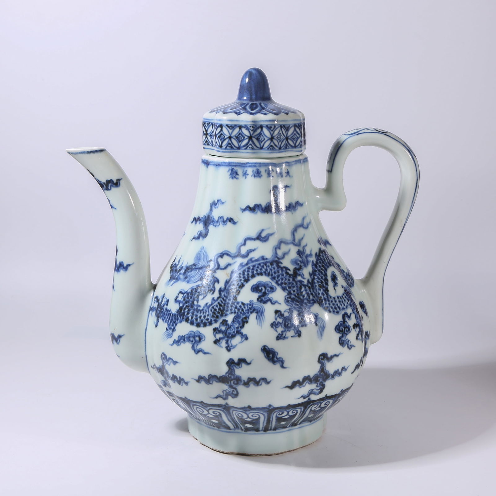 A BLUE-AND-WHITE MELON-RIBBED EWER WITH CLOUD-AND-DRAGON MOTIFS (1 of 11)