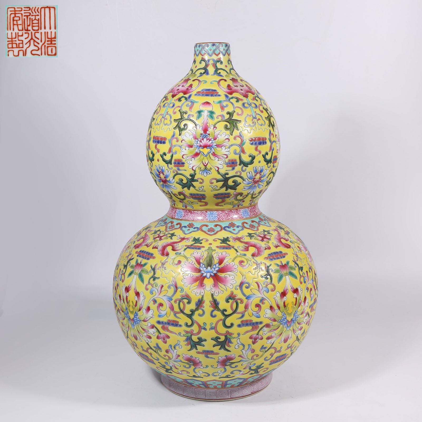 A YELLOW-GROUND FAMILLE-ROSE GOURD-SHAPED VASE WITH BAOXIANG FLOWER MOTIFS (1 of 9)