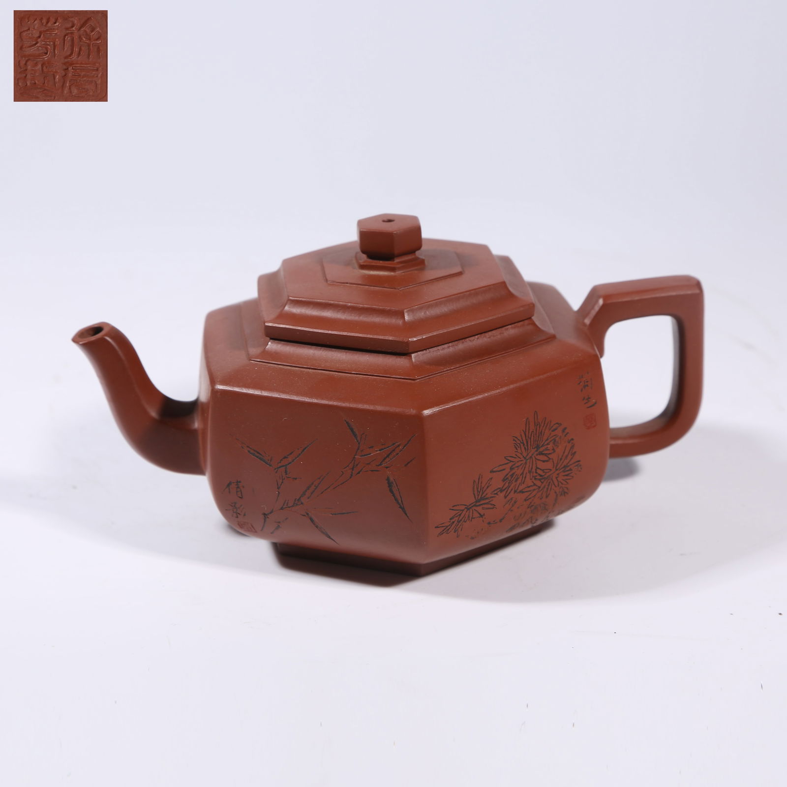 A ZISHA HEXAGONAL TEAPOT WITH PLUM, ORCHID, BAMBOO, AND CHRYSANTHEMUM MOTIF (1 of 8)
