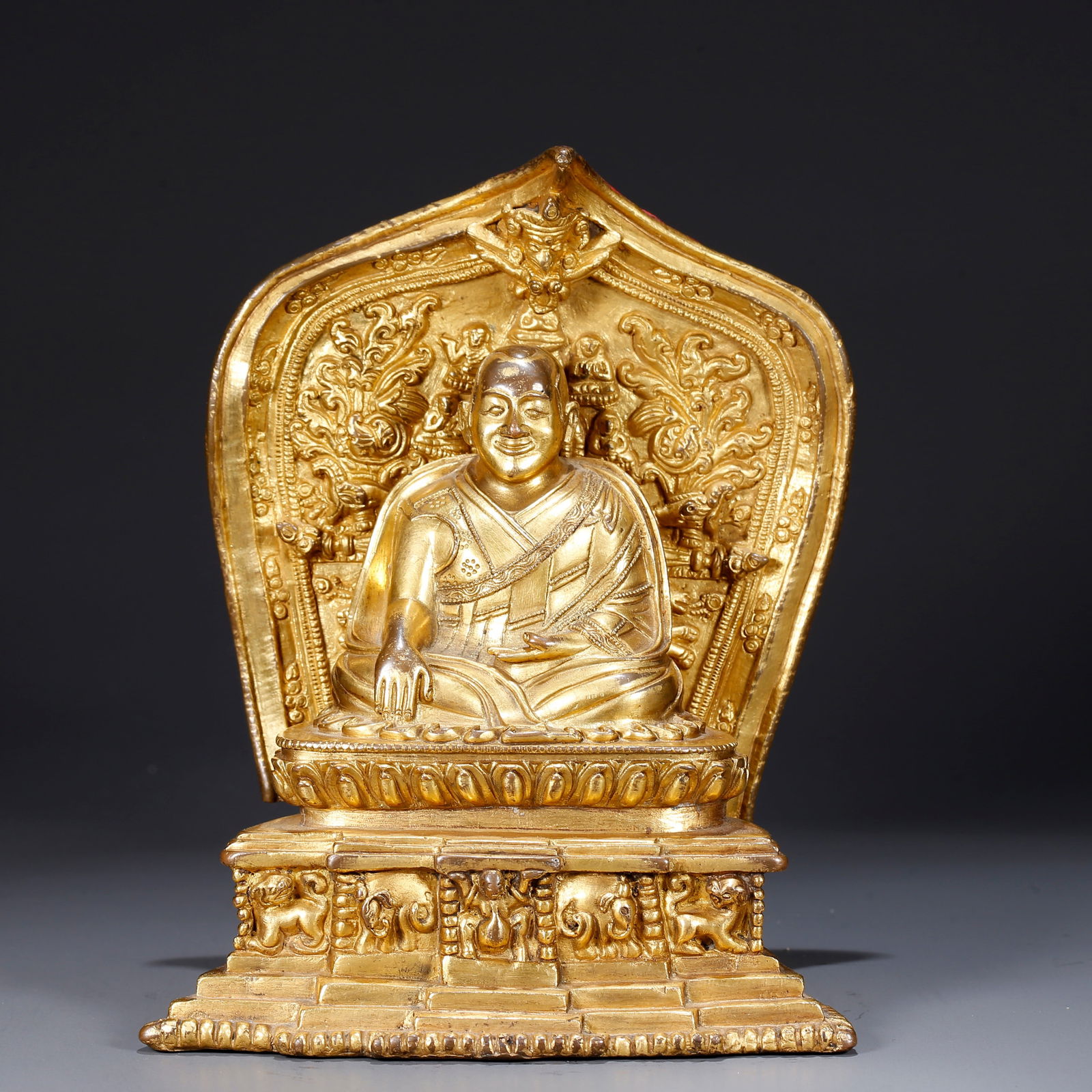 A GILDED BRONZE STATUE OF A LAMA: Gilded Bronze Statue of a Lama