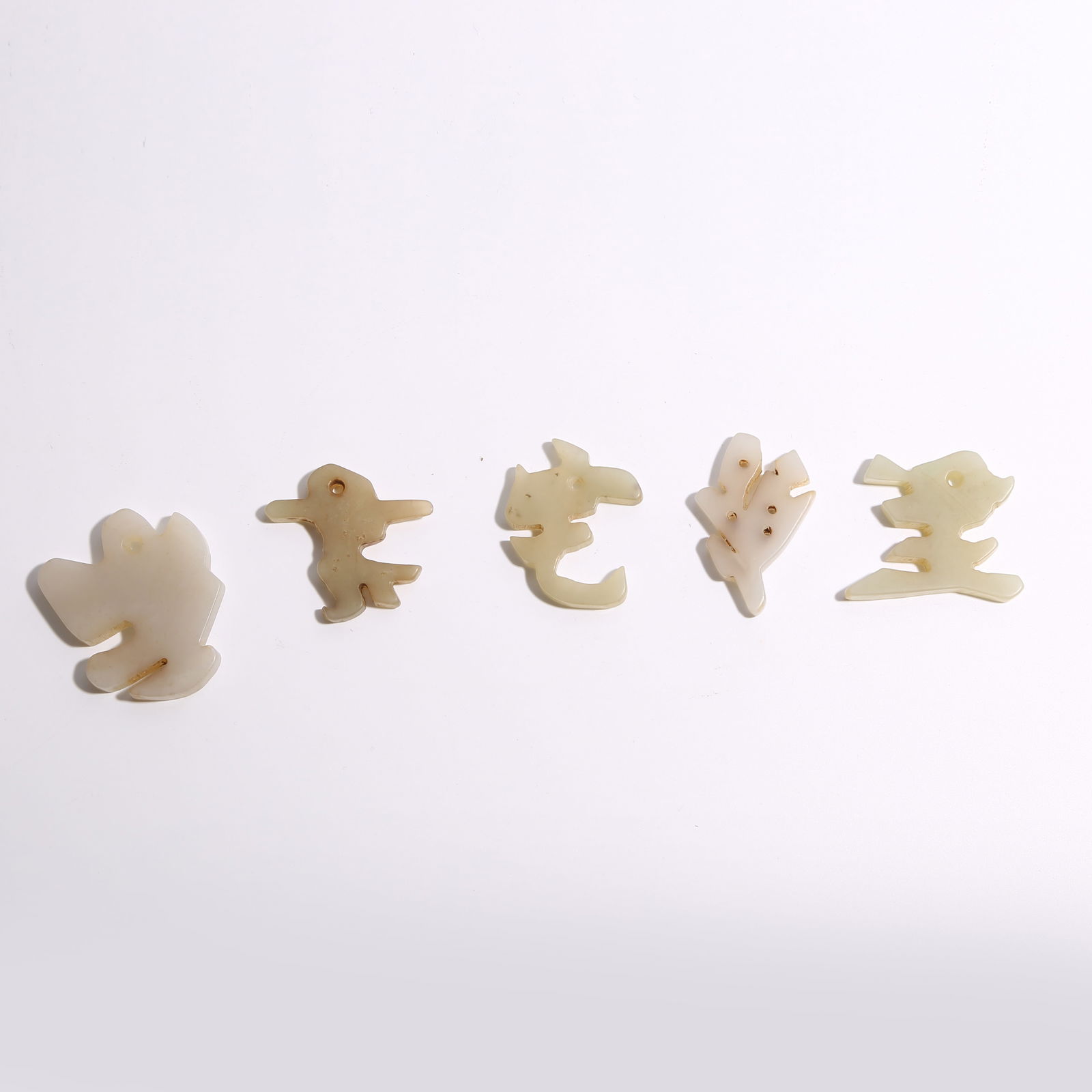 A QING DYNASTY HETIAN JADE FLOWER PLAQUES, SET (1 of 9)