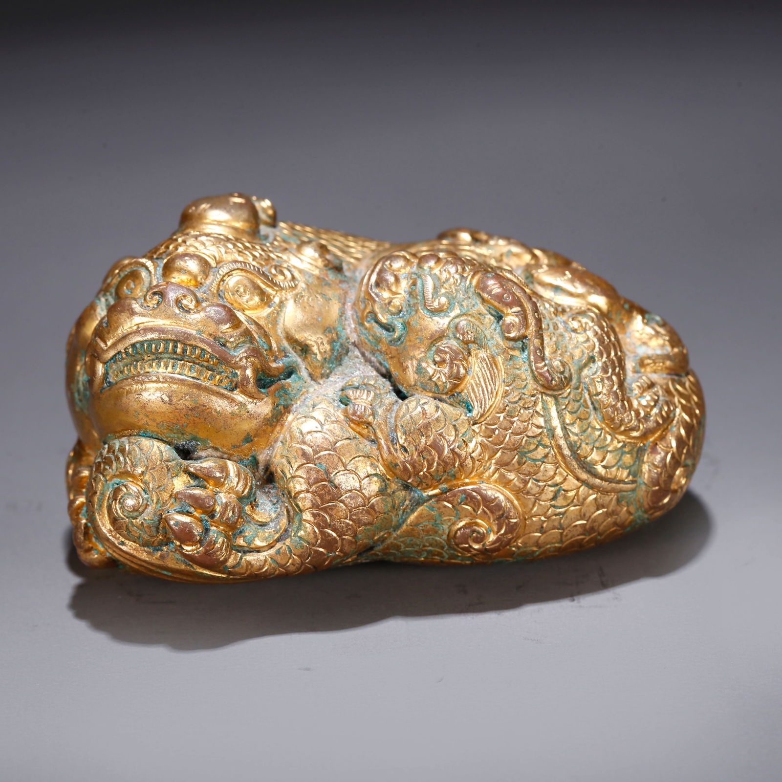 A GILT BRONZE AUSPICIOUS BEAST-SHAPED ORNAMENT (1 of 9)