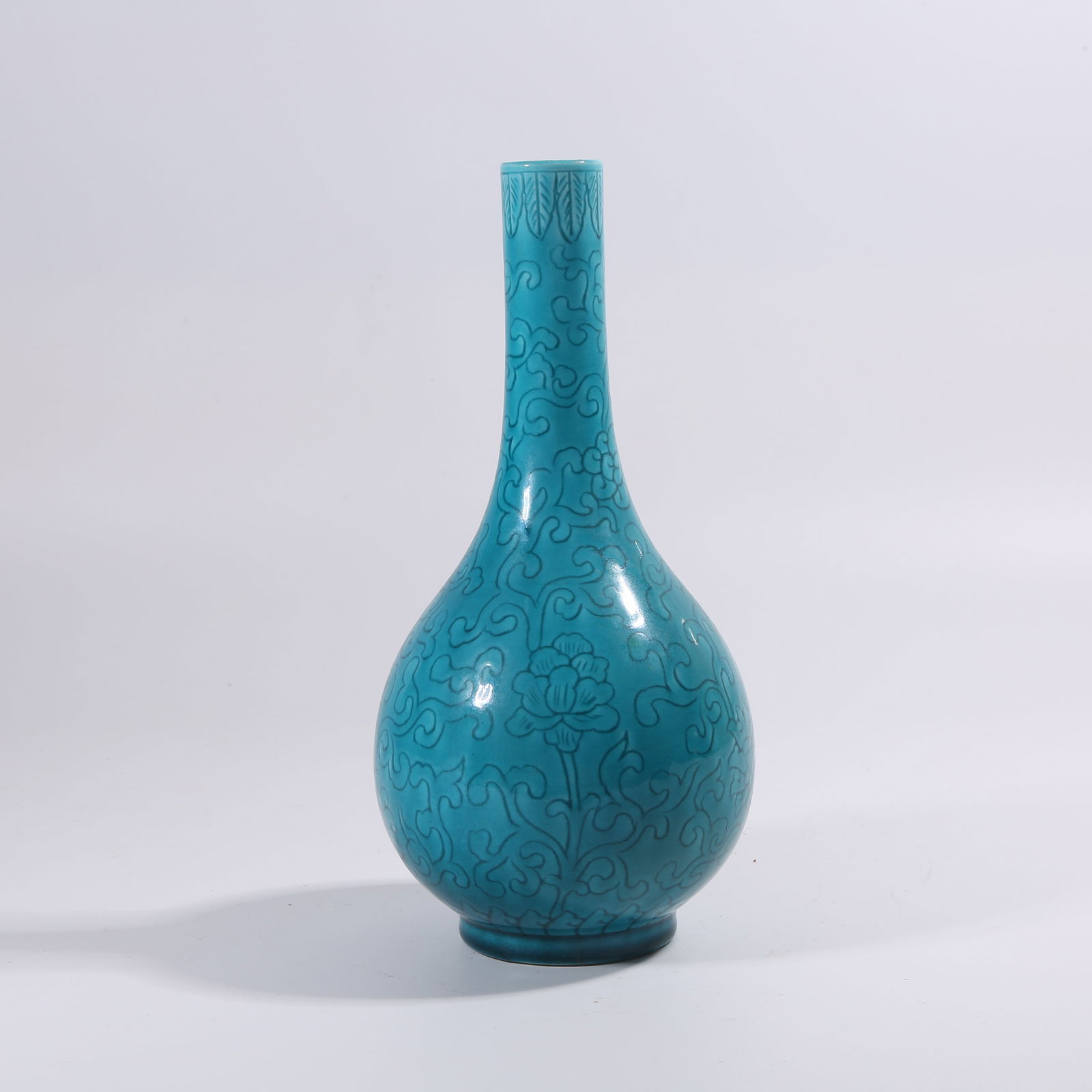 A MING DYNASTY PEACOCK-BLUE GLAZE INCISED FLORAL PATTERN DAN BOTTLE (1 of 10)