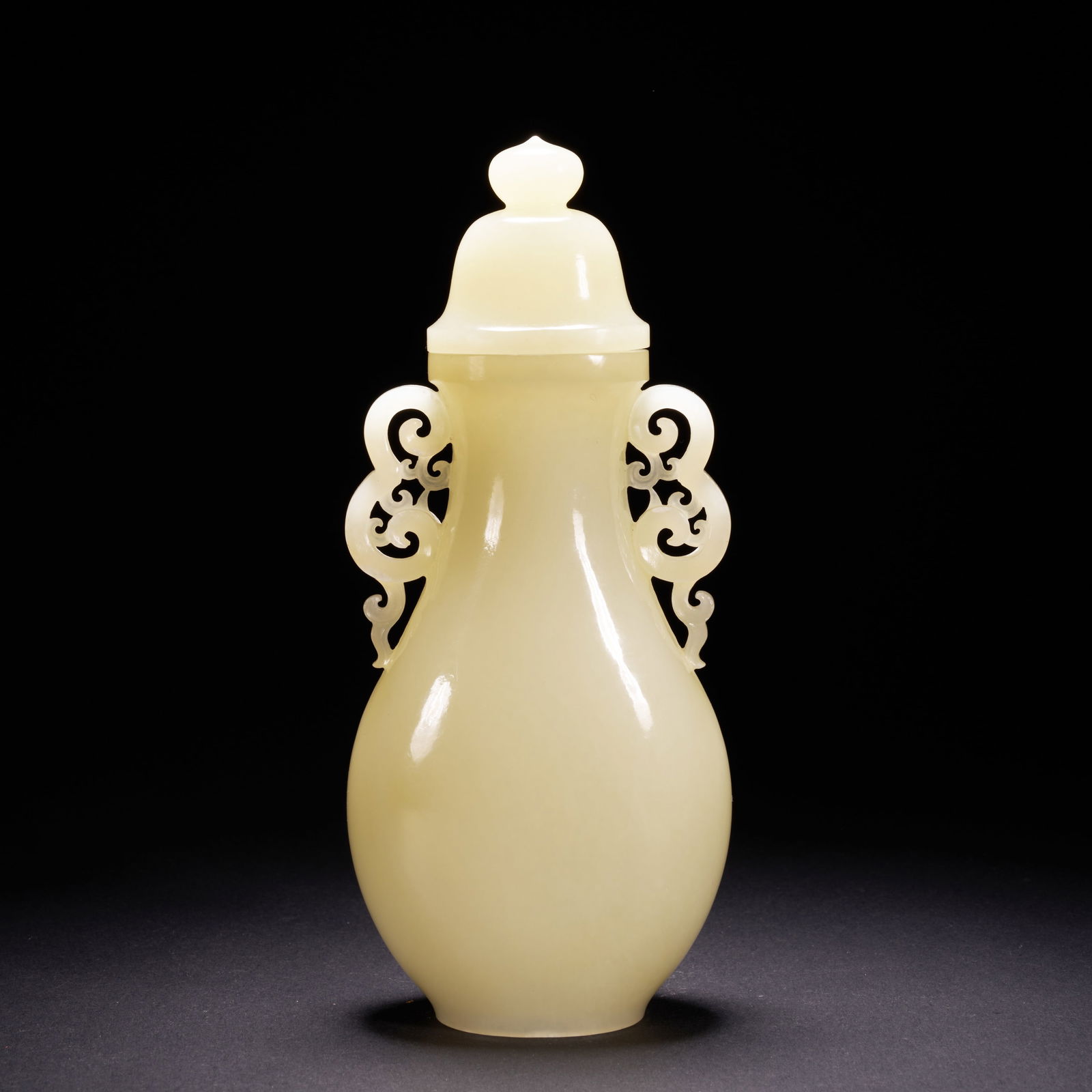 A HETIAN JADE OPENWORK VASE WITH RUYI-SHAPED HANDLES, QING DYNASTY (1 of 8)
