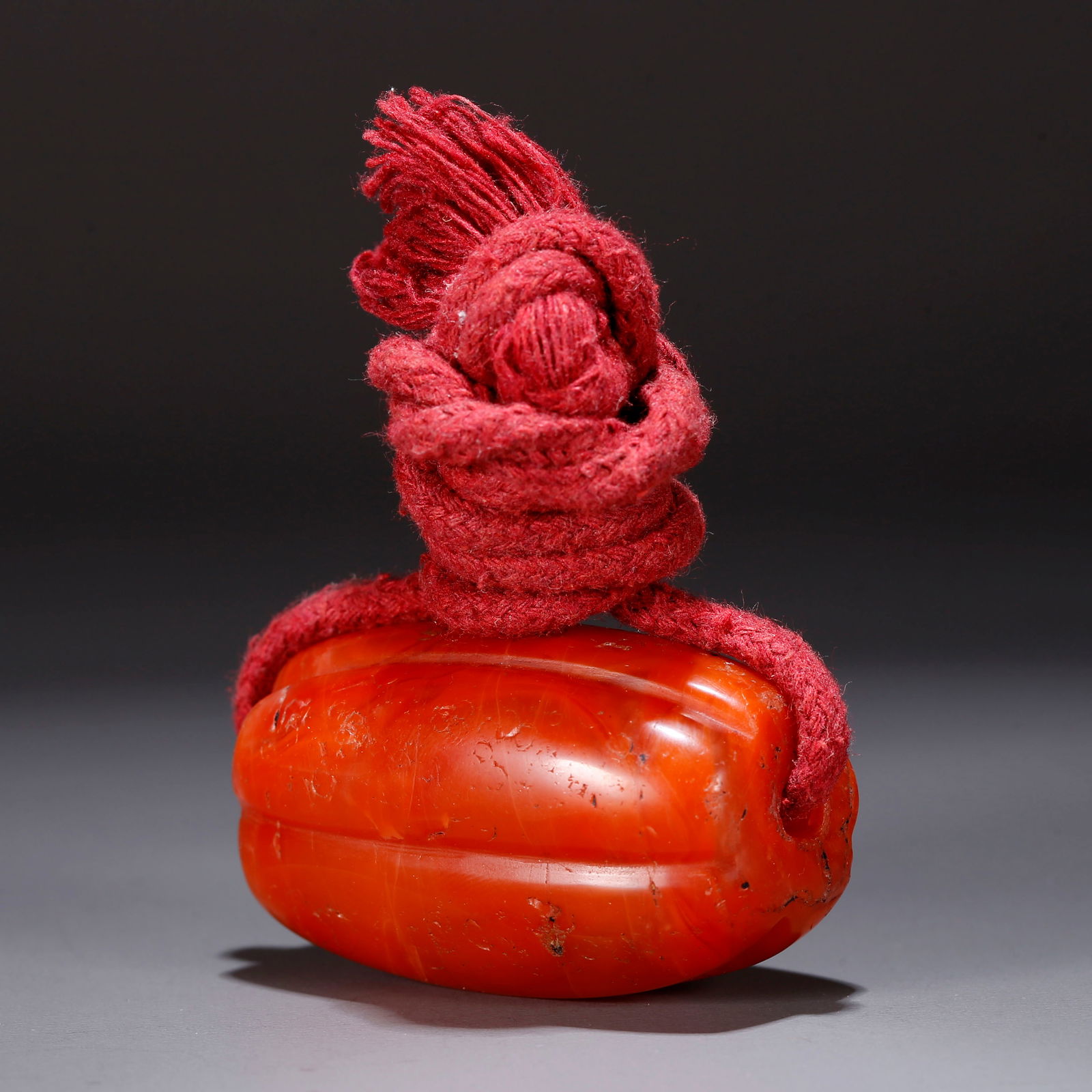 A SOUTHERN RED AGATE PENDANT CARVED WITH MELONS AND FRUITS (1 of 10)