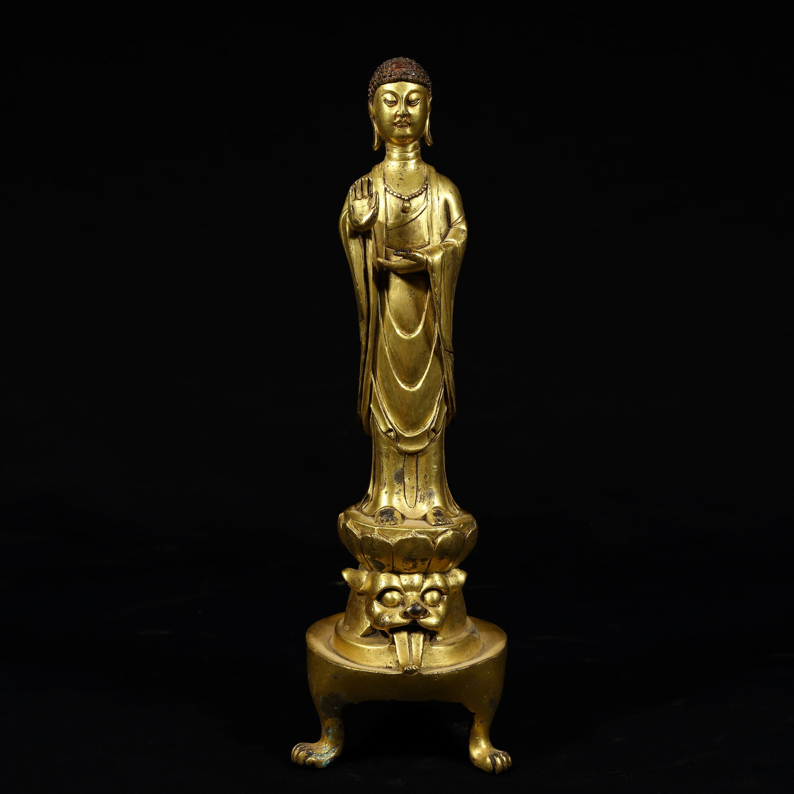A GILDED BRONZE STANDING BUDDHA SCULPTURE (1 of 8)