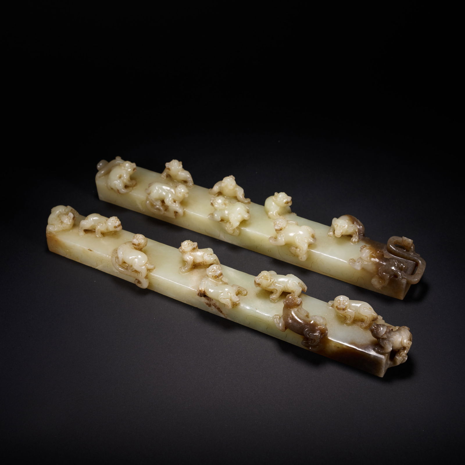 A PAIR OF HETIAN JADE NINE-BEAR PAPERWEIGHTS, HAN DYNASTY (1 of 6)