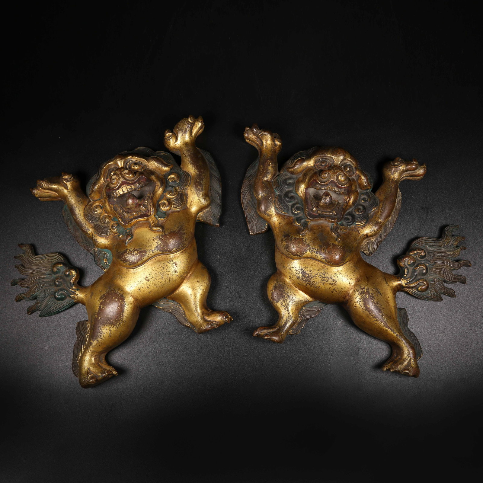 A GILT BRONZE DHARMA PROTECTOR LIONS, A SET (1 of 9)