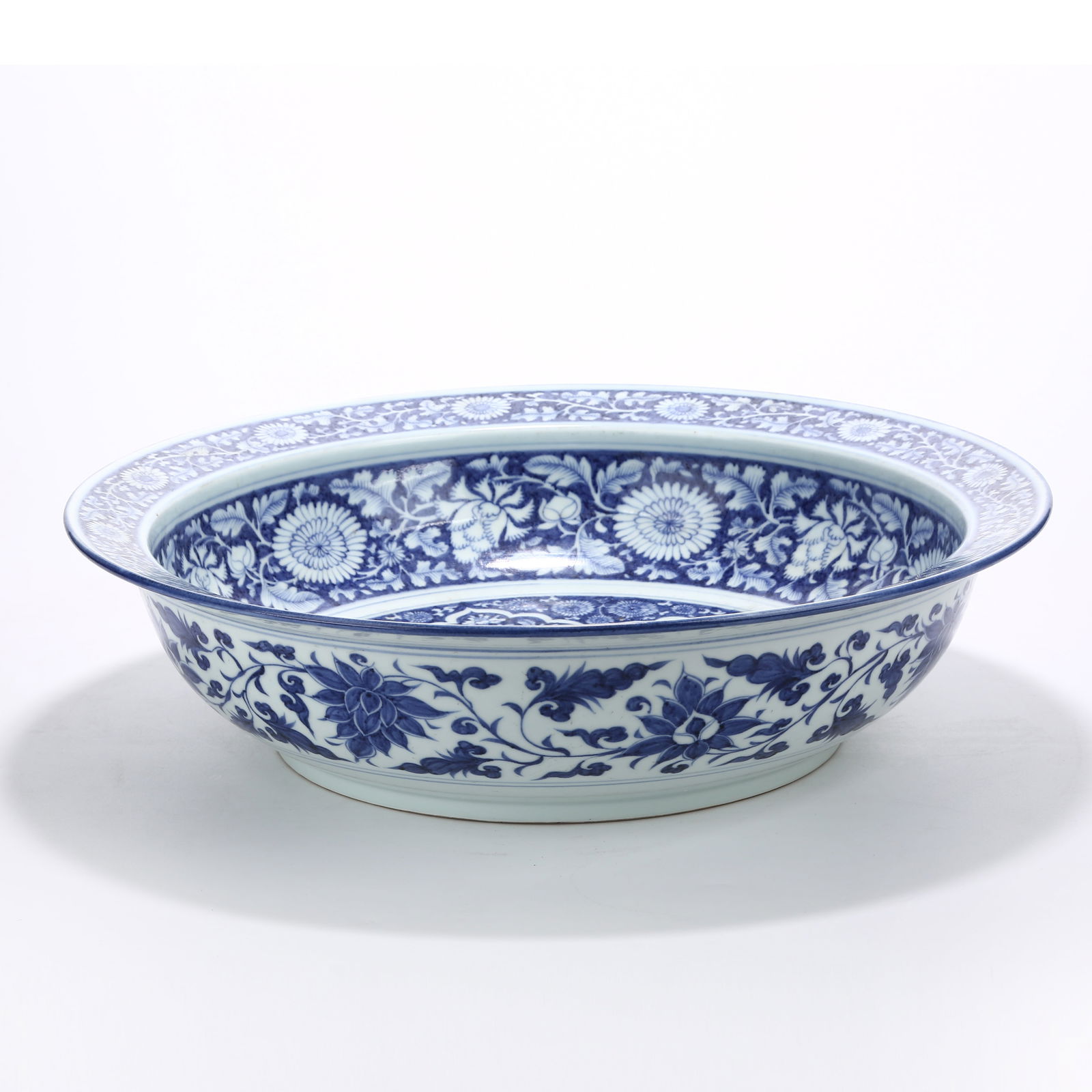 A BLUE AND WHITE FLARED BASIN WITH SCROLLING CHRYSANTHEMUM DESIGN: Blue and White Flared Basin with Scrolling Chrysanthemum Design