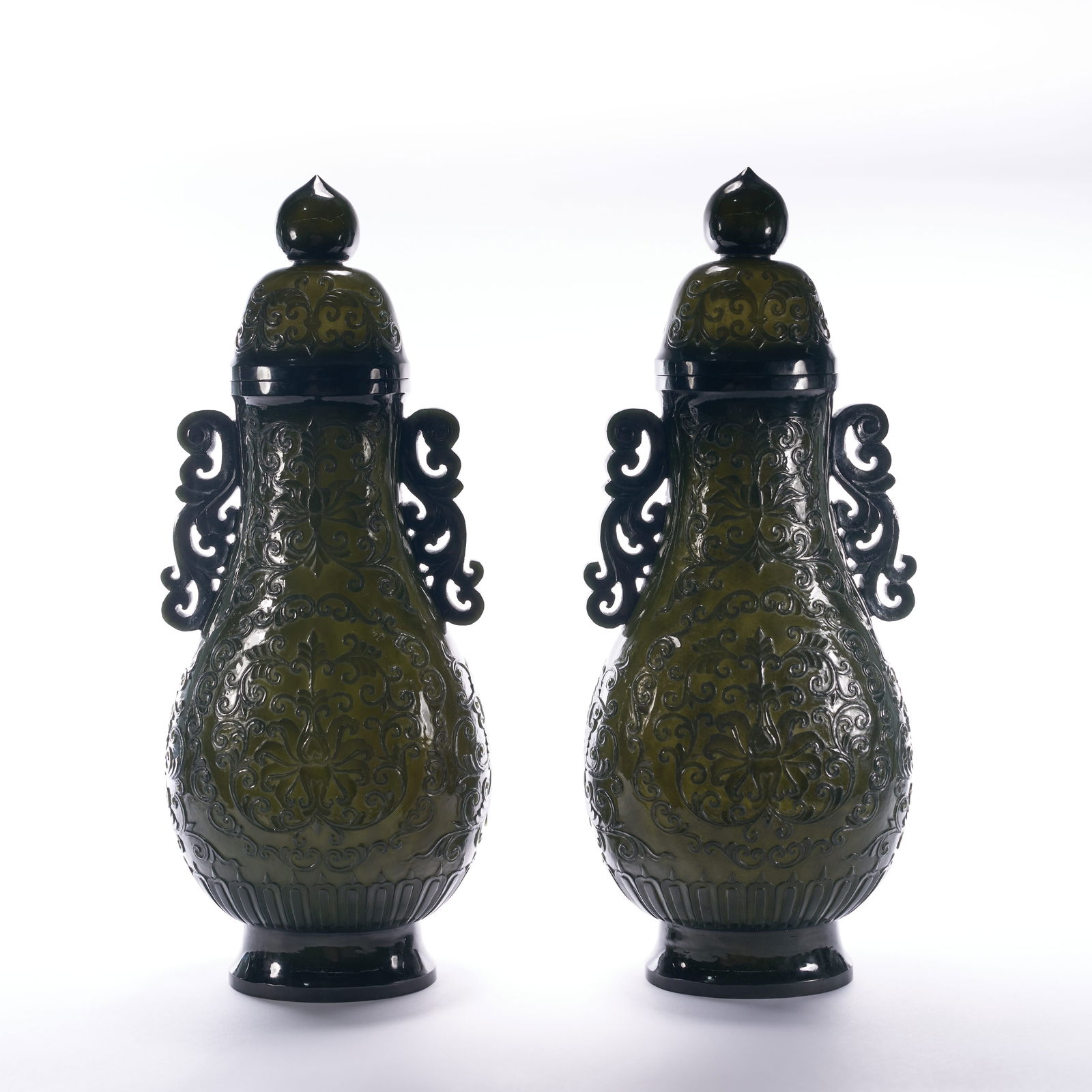 A A SET OF HETIAN SPINACH-GREEN JADE VASES WITH FLORAL MOTIFS, QING DYNASTY (1 of 8)