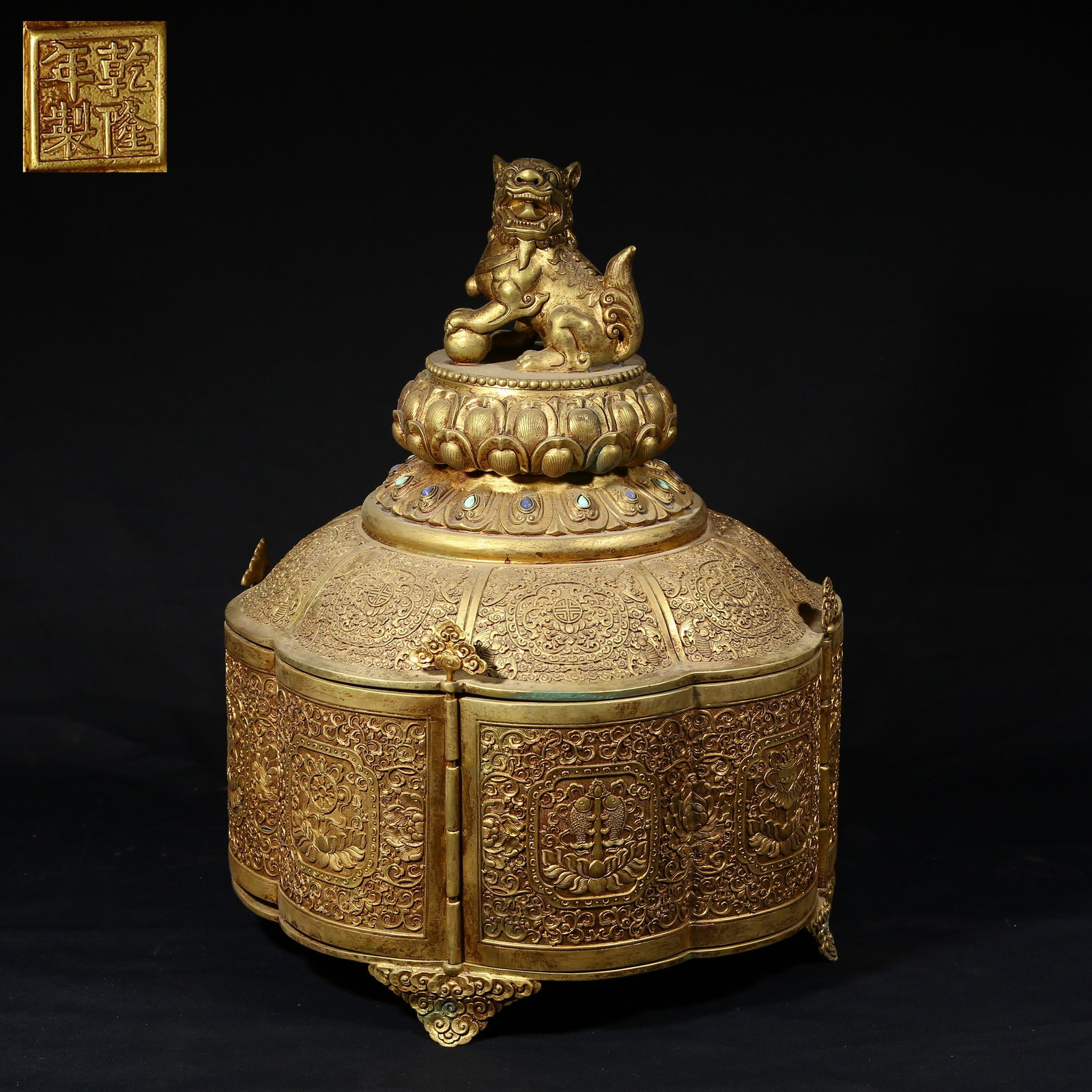 A GILDED BRONZE TREASURE BOX WITH LION KNOB AND EIGHT AUSPICIOUS SYMBOLS (1 of 10)