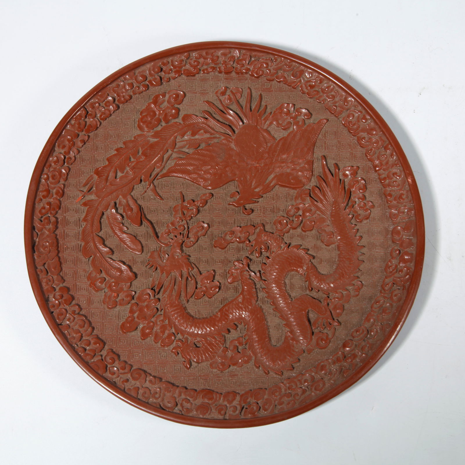 A CARVED RED LACQUER PLATE WITH DRAGON AND PHOENIX DESIGN (1 of 9)