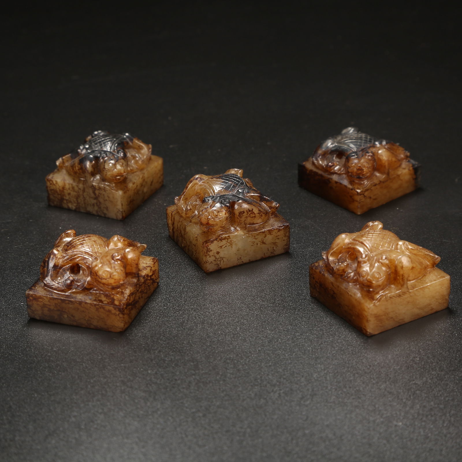 A SET OF ANCIENT JADE AUSPICIOUS BEAST-HANDLE SEALS (1 of 8)