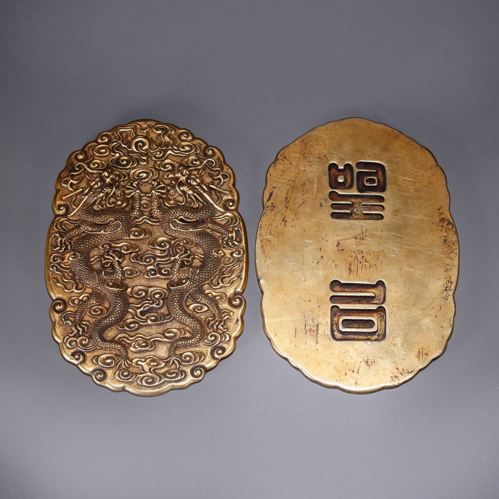 A GILT BRONZE TOKEN WITH CLOUD-AND-DRAGON DESIGN (1 of 11)