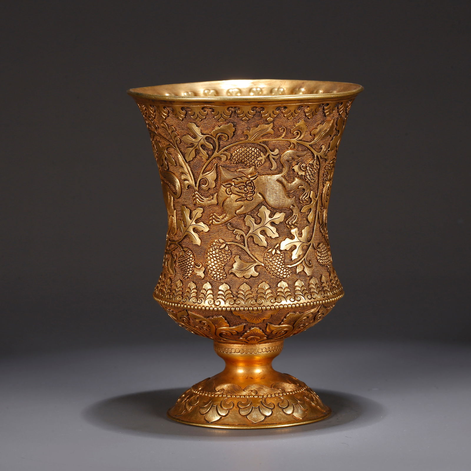 A GILT BRONZE CUP WITH AUSPICIOUS BEAST PATTERN: Gilt Bronze Cup with Auspicious Beast Pattern