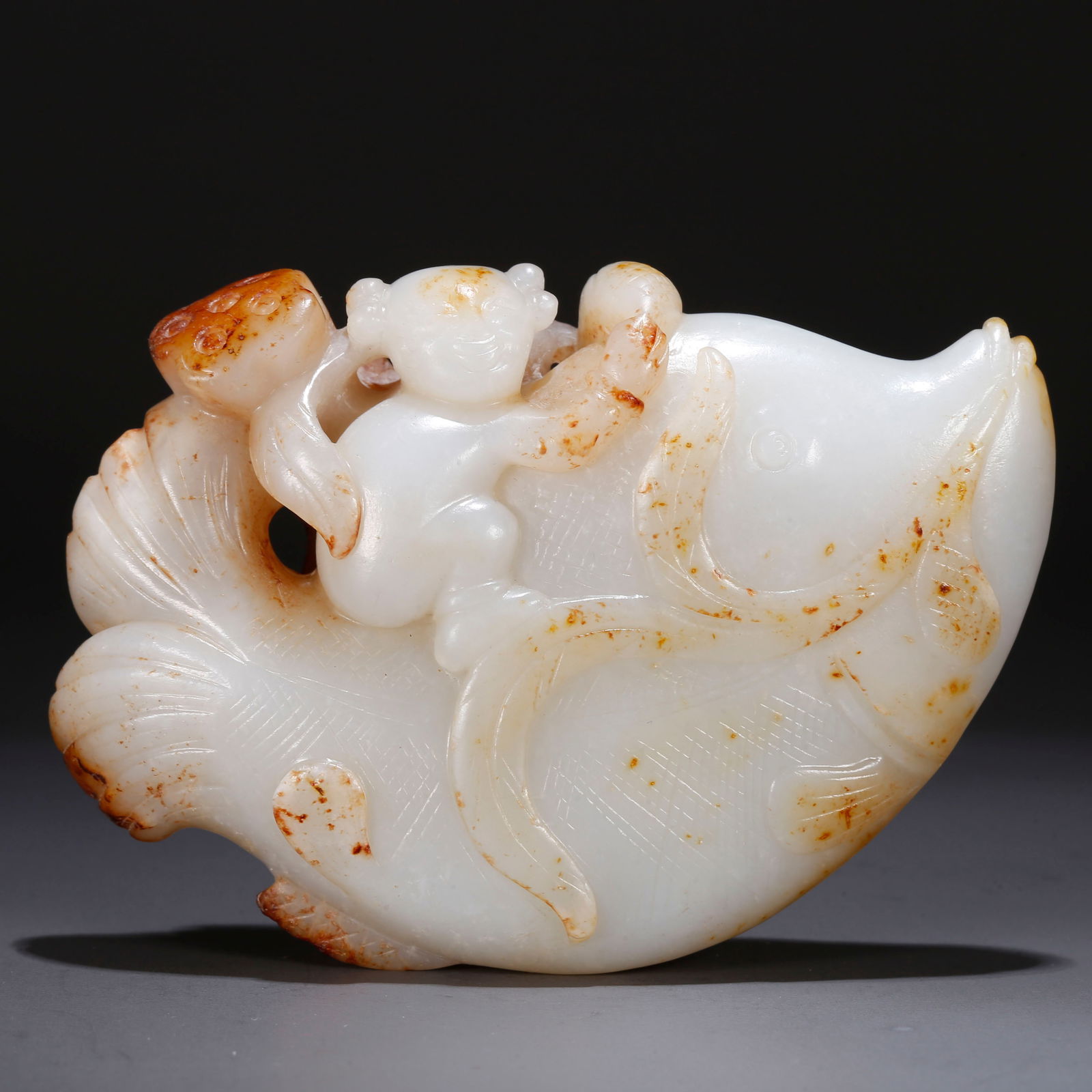 A HETIAN JADE ORNAMENT CARVED WITH FISH AND MAN (1 of 10)