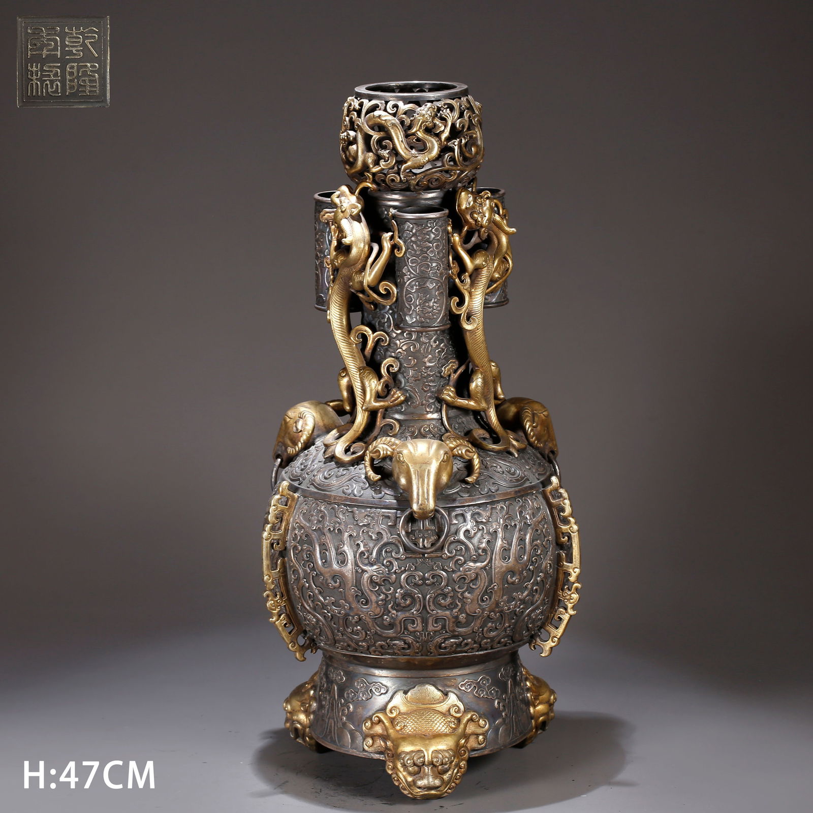 A GILT BRONZE TRIPLE-LOOP-HANDLED VASE: Gilt bronze triple-loop-handled vase