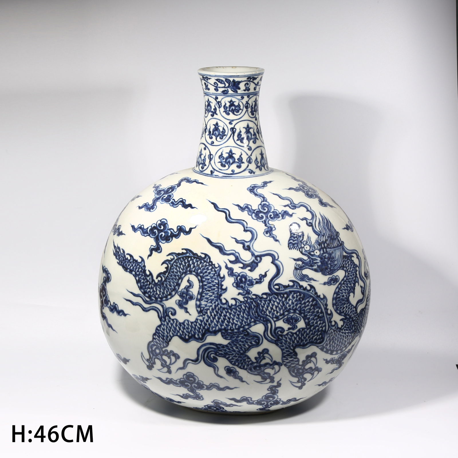 A BLUE AND WHITE CLOUD-AND-DRAGON PATTERN LARGE MOON FLASK (1 of 10)