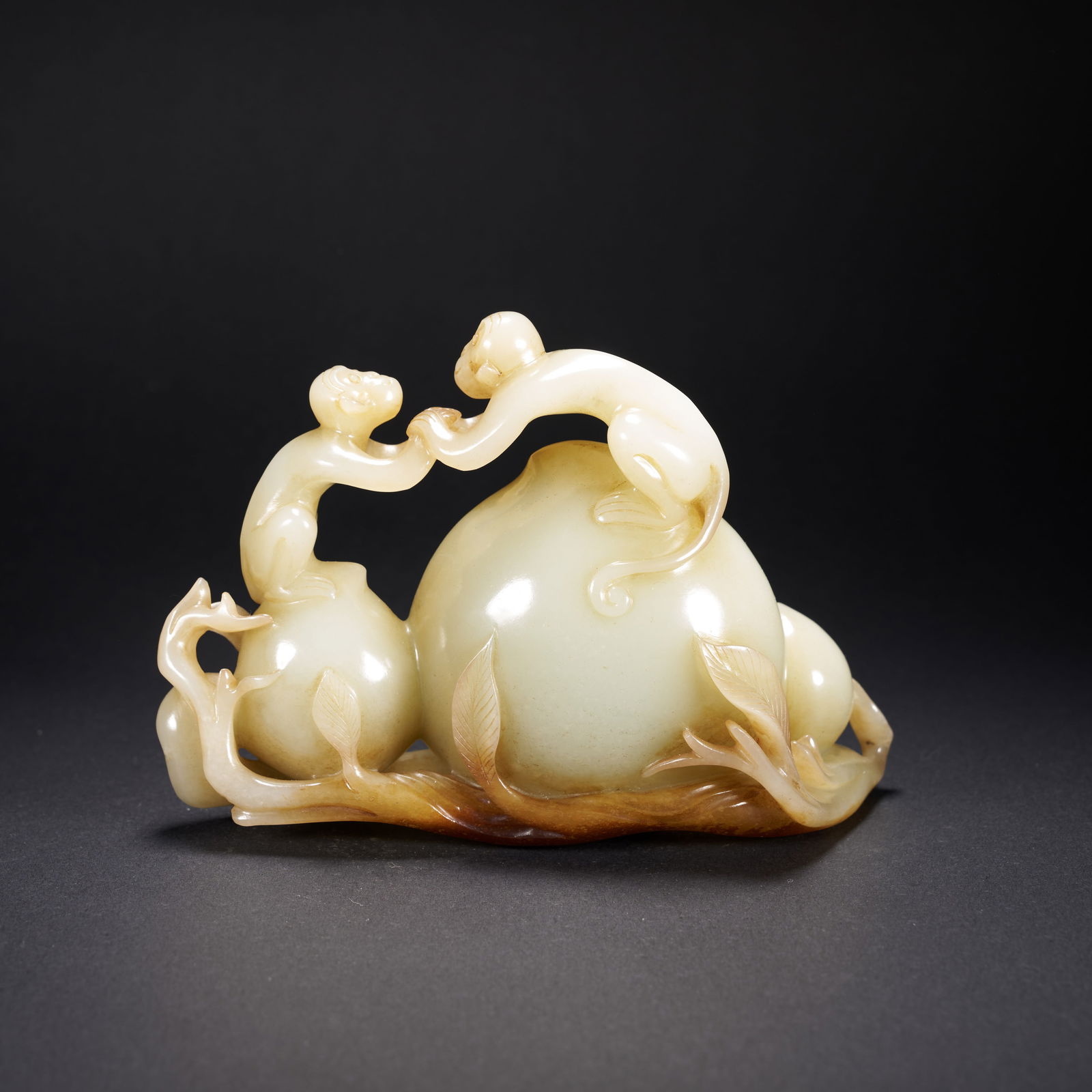 A HETIAN JADE "AUSPICIOUS MONKEY PRESENTING LONGEVITY" ORNAMENT, QING DYNASTY (1 of 6)