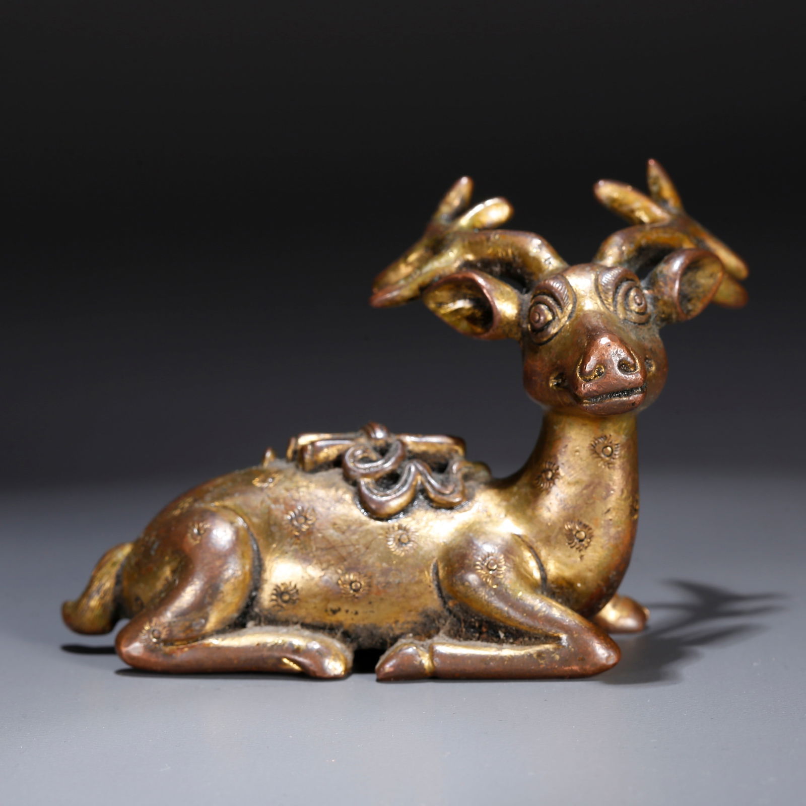 A GILT BRONZE ORNAMENT IN THE SHAPE OF AN ELK (1 of 10)