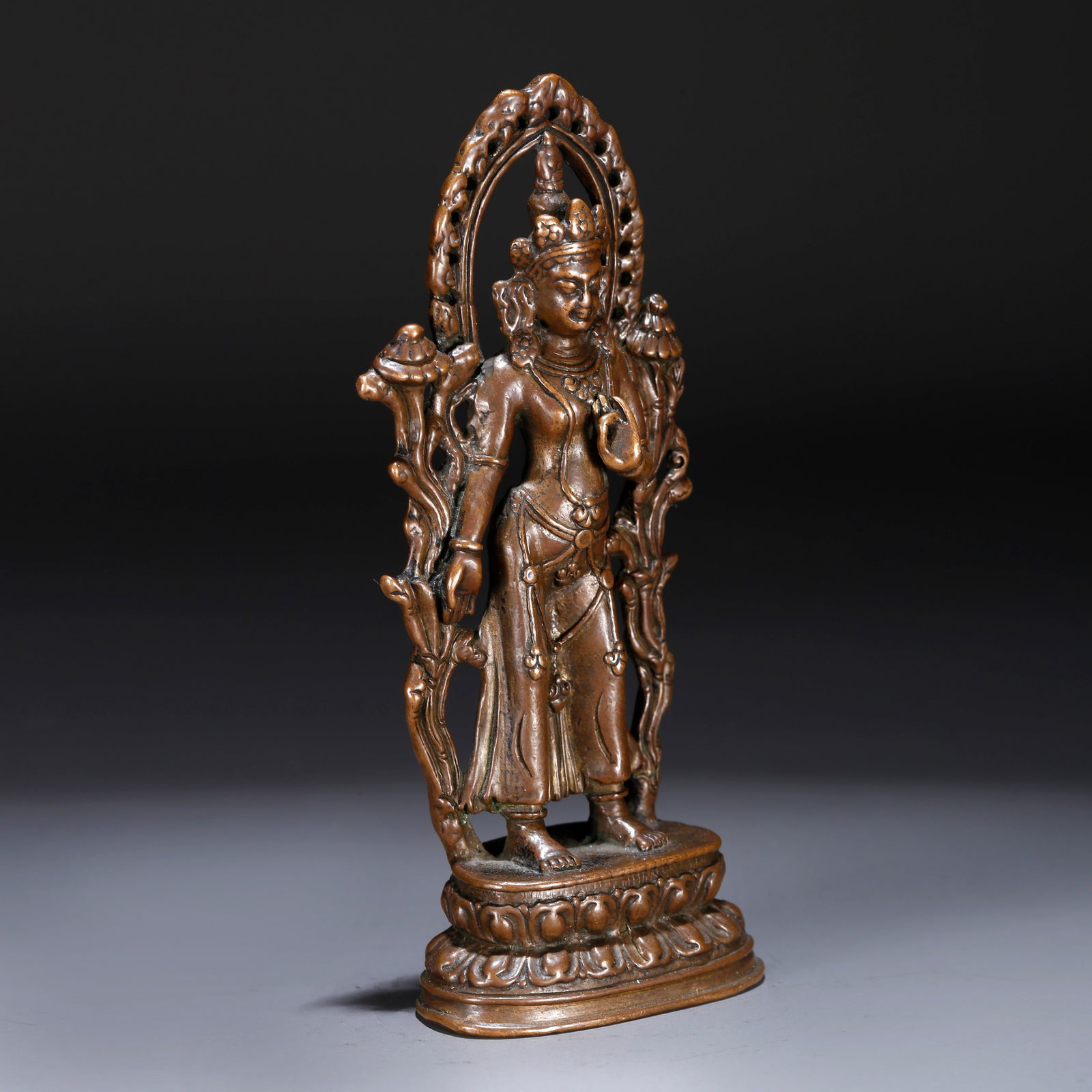 A BRONZE STANDING STATUE OF GUANYIN HOLDING A LOTUS (1 of 10)