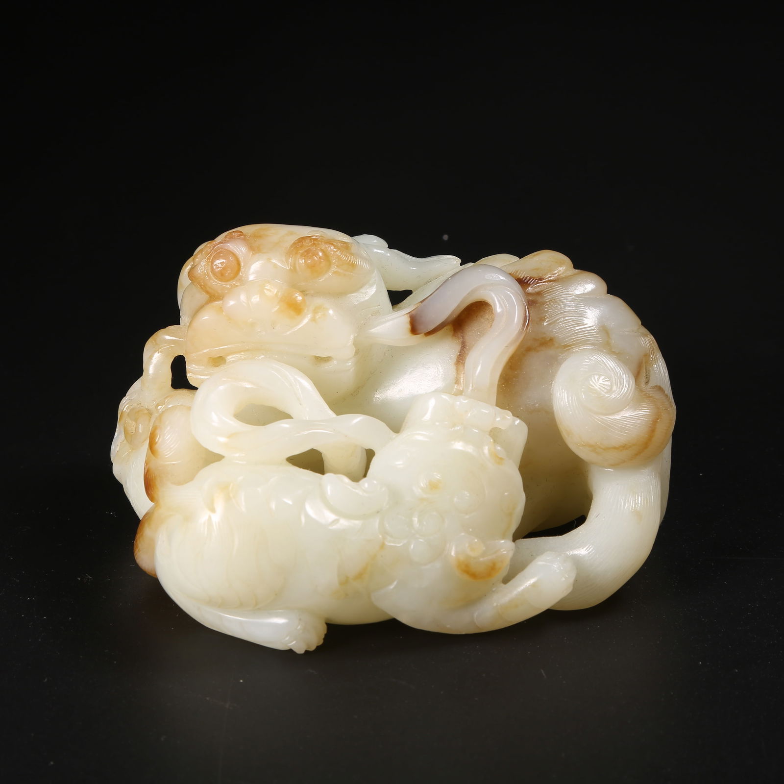 A HETIAN JADE ORNAMENT OF A LION PLAYING WITH A BROCADE BALL (1 of 8)
