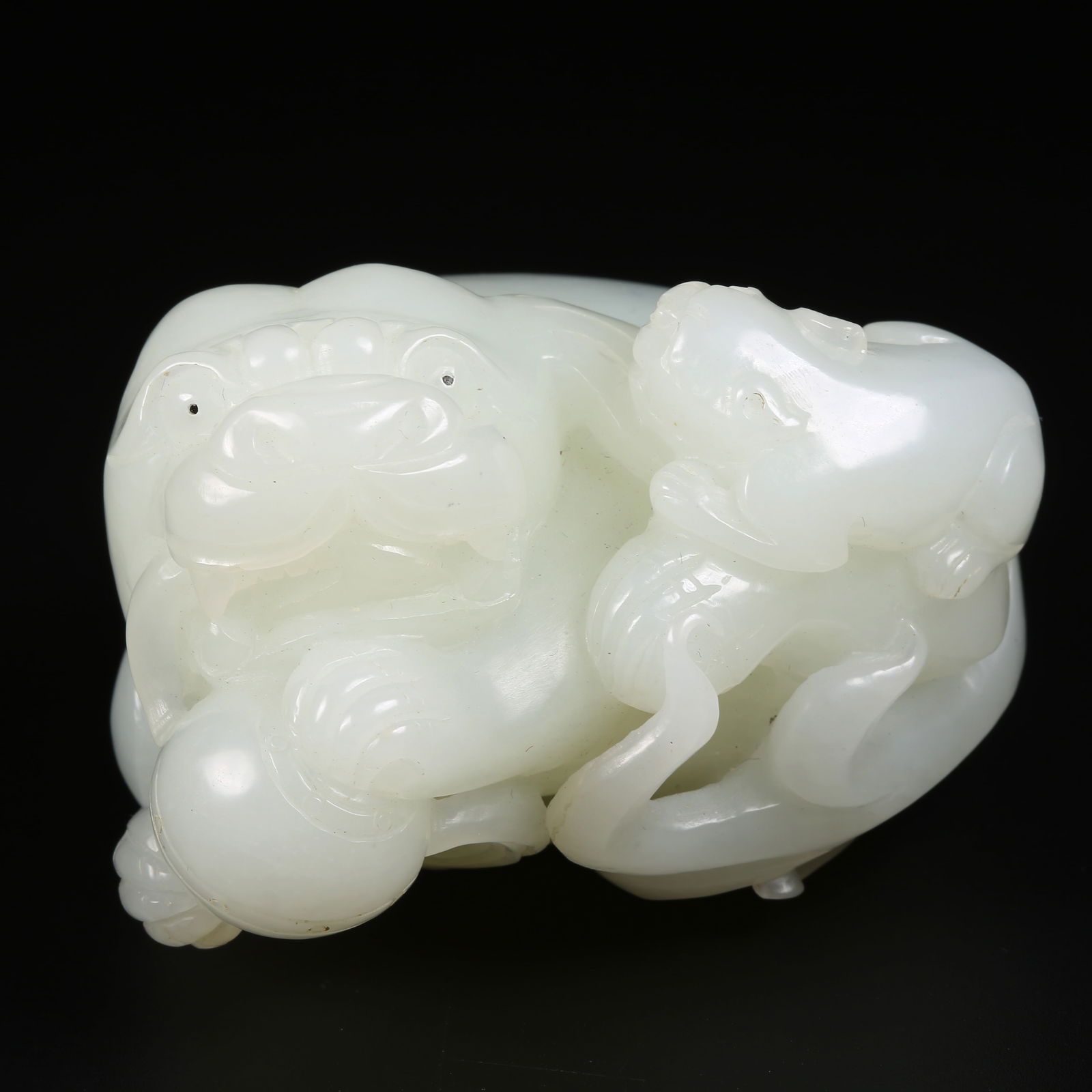 A HETIAN JADE ORNAMENT OF A LION PLAYING WITH A BROCADE BALL (1 of 8)