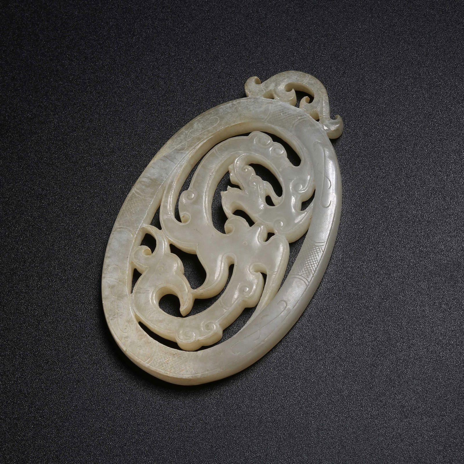 A ARCHAIC JADE PENDANT WITH DRAGON MOTIFS (1 of 8)