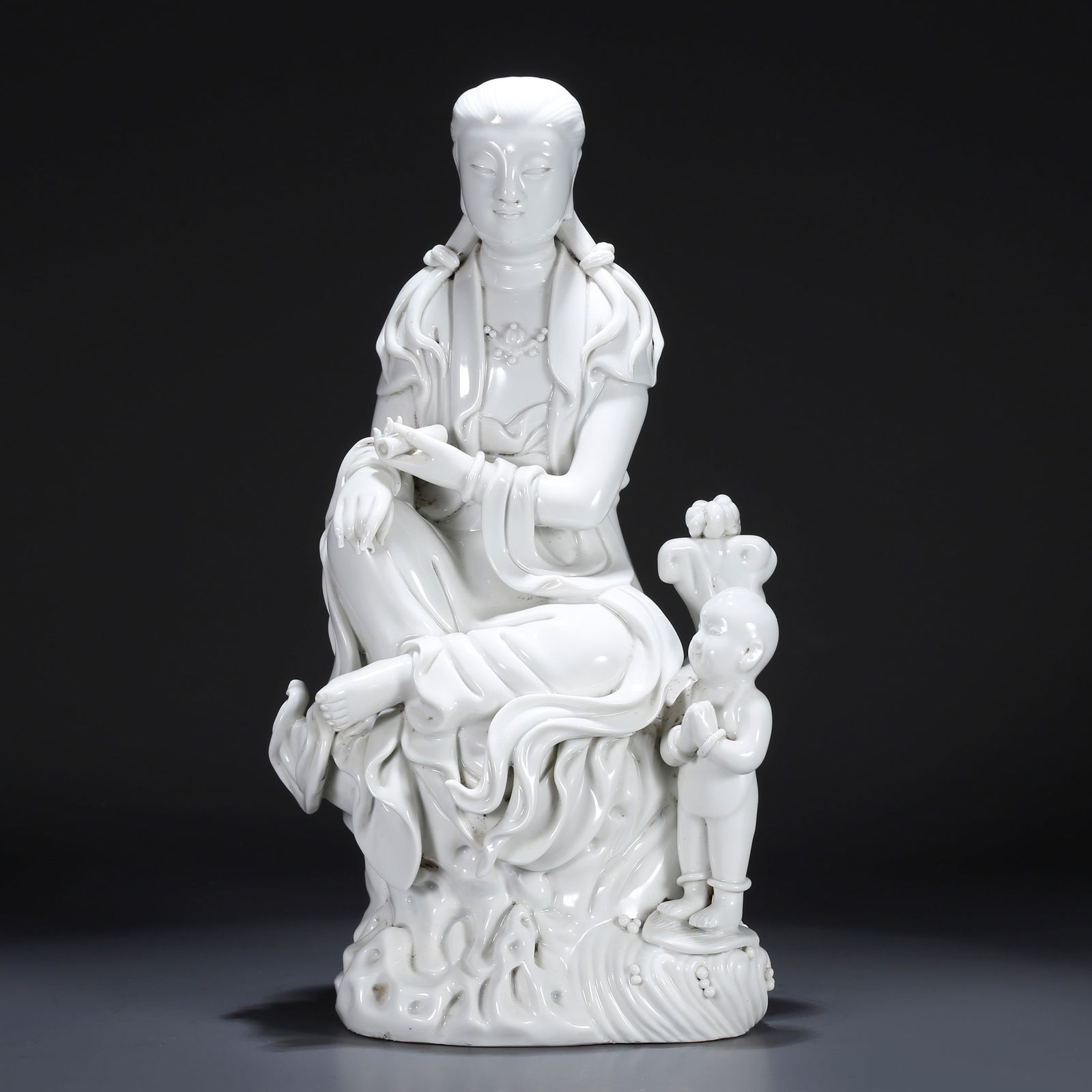 A WHITE PORCELAIN FIGURE OF GUANYIN WITH CHILD (1 of 10)