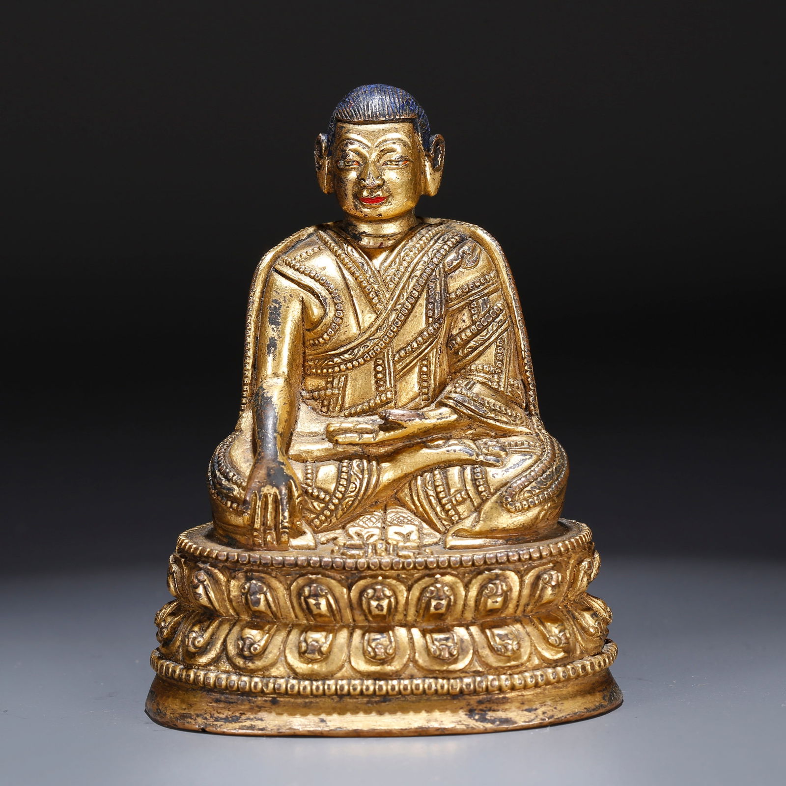 A GILT BRONZE STATUE OF A LAMA: Gilt Bronze Statue of a Lama