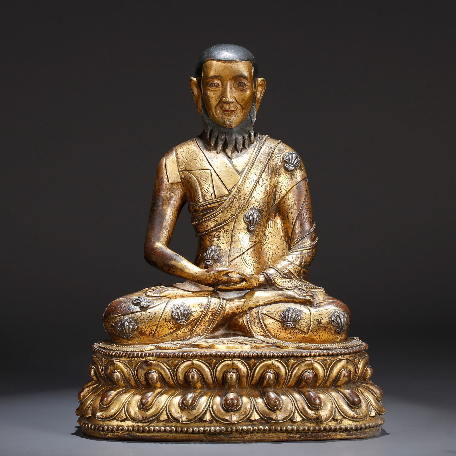 A GILT BRONZE STATUE OF A LAMA: Gilt Bronze Statue of a Lama