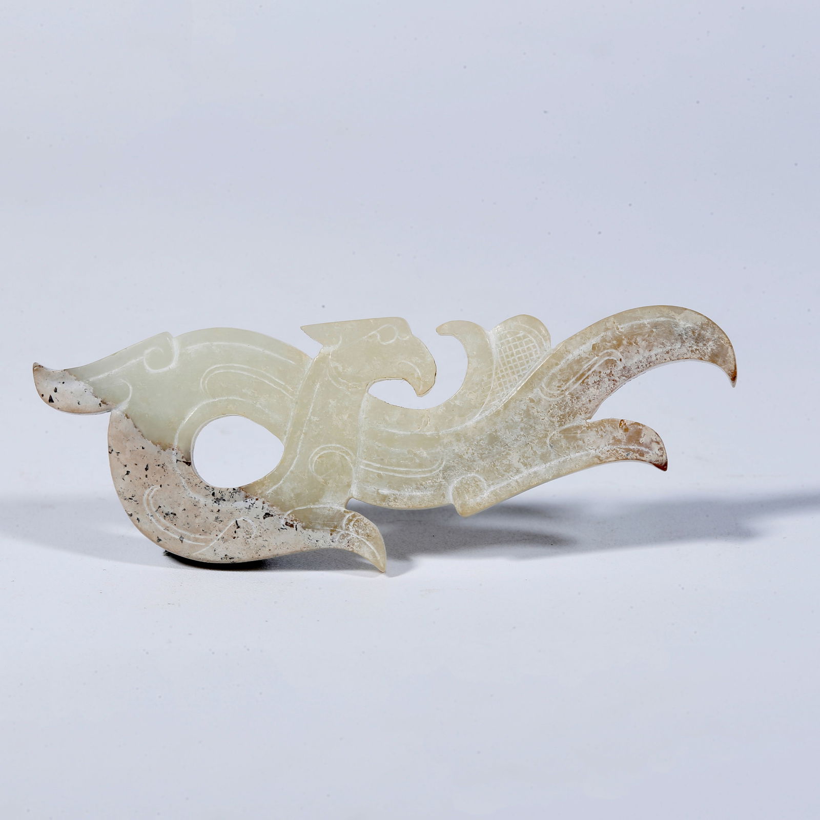 A HETIAN JADE PENDANT CARVED IN THE SHAPE OF AN AUSPICIOUS BEAST (1 of 9)