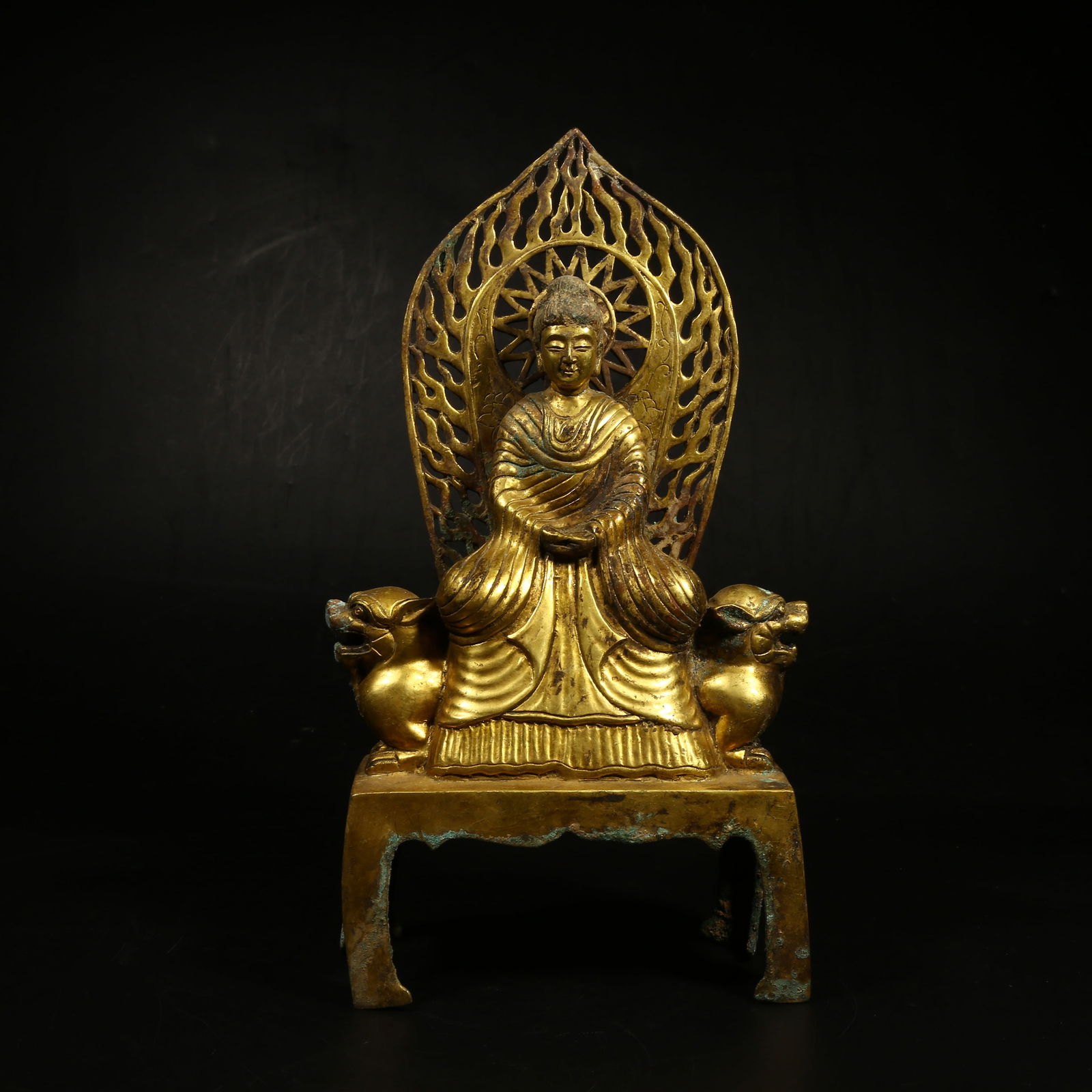 A GILT-BRONZE FIGURE OF SHAKYAMUNI BUDDHA: Gilt-Bronze Figure of Shakyamuni Buddha