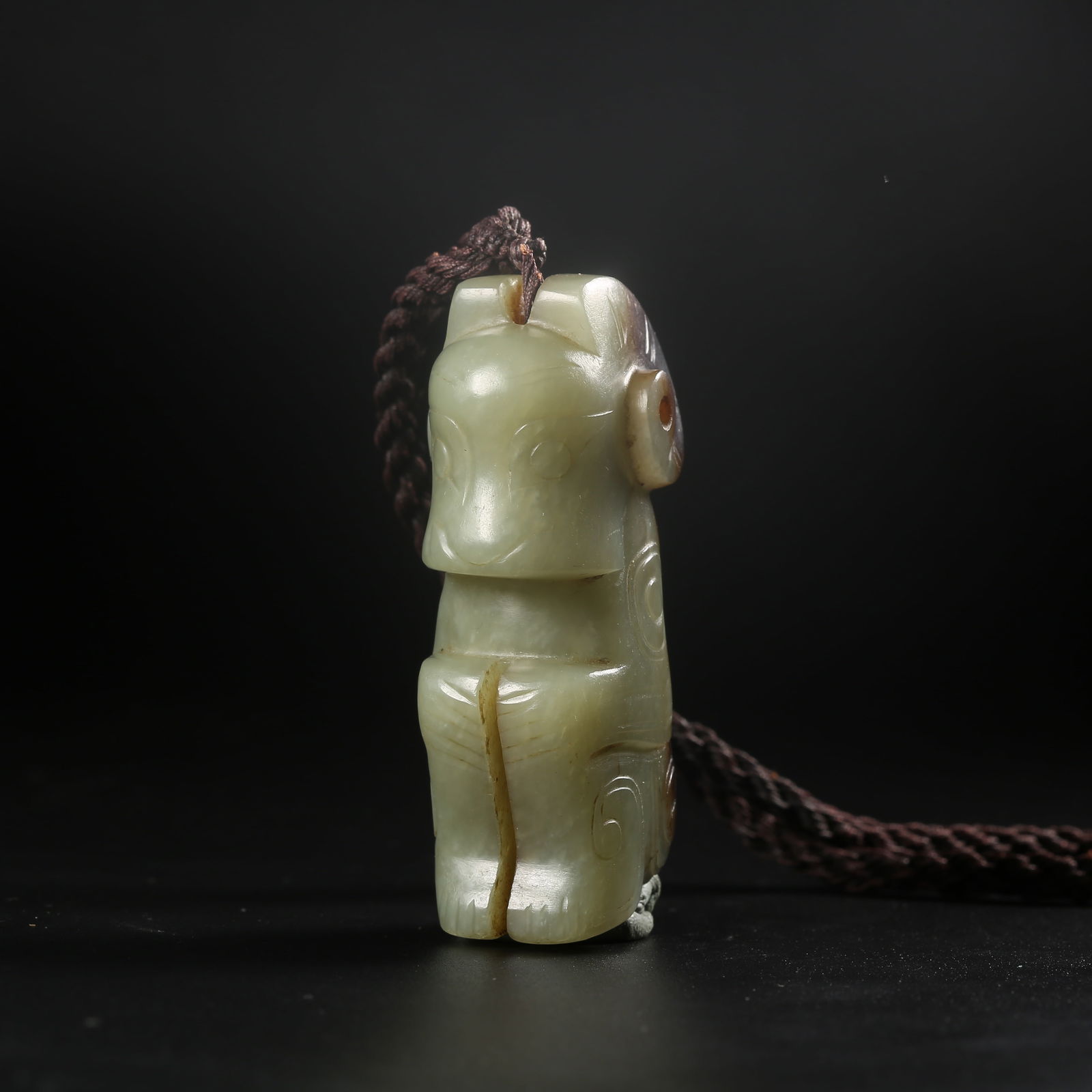 A ARCHAIC JADE PENDANT CARVED WITH A DEITY MASK (1 of 8)