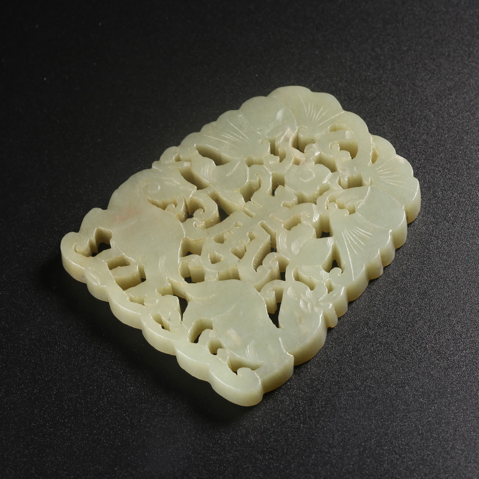 A HETIAN JADE PENDANT CARVED WITH AUSPICIOUS BEAST MOTIFS (1 of 9)