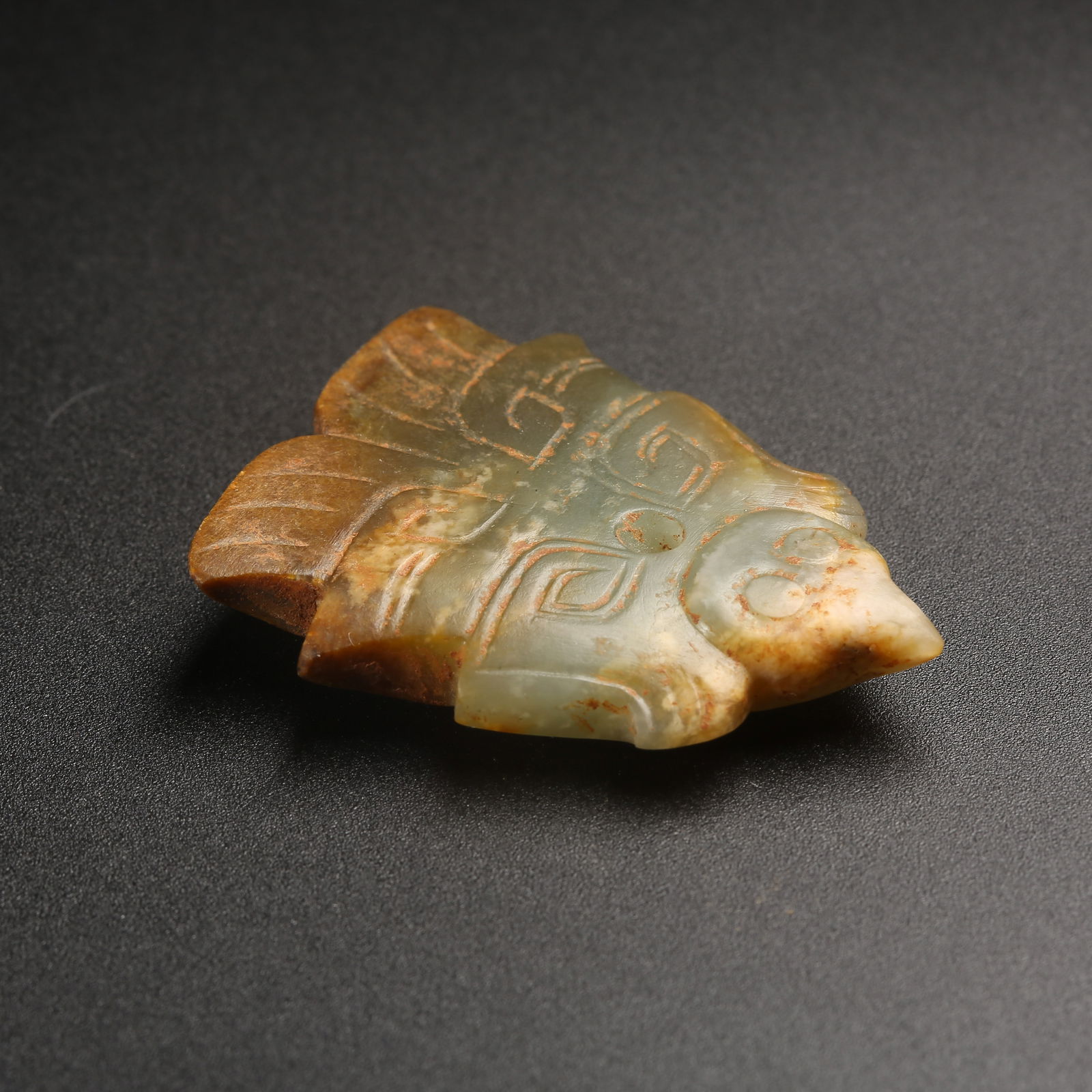 A ARCHAIC JADE DEITY WITH HUMAN FACE AND PHOENIX PENDANT (1 of 8)