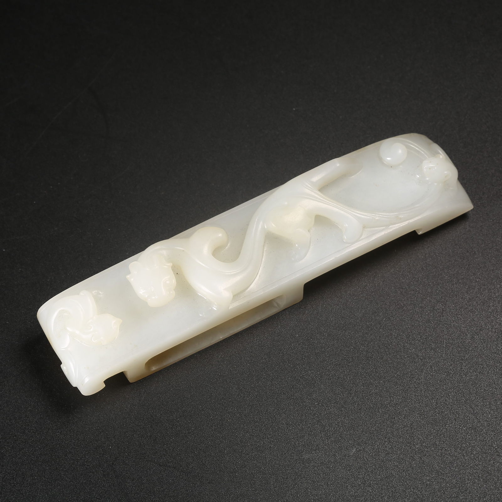A HETIAN WHITE JADE SWORD-PIG WITH CHI-DRAGON MOTIF (1 of 9)