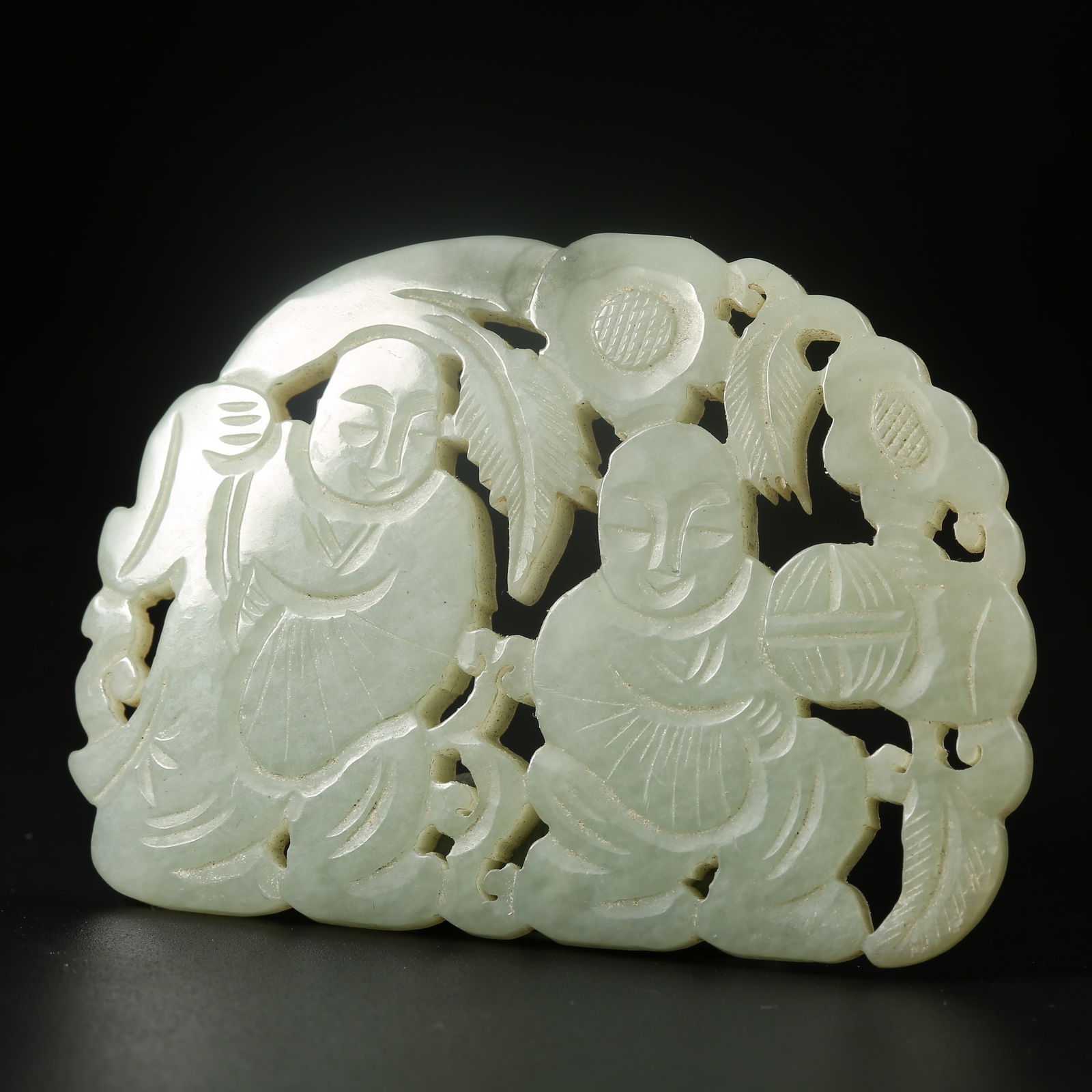 A HETIAN JADE PENDANT CARVED WITH THE HEHE TWINS MOTIF: Hetian jade pendant carved with the Hehe Twins motif