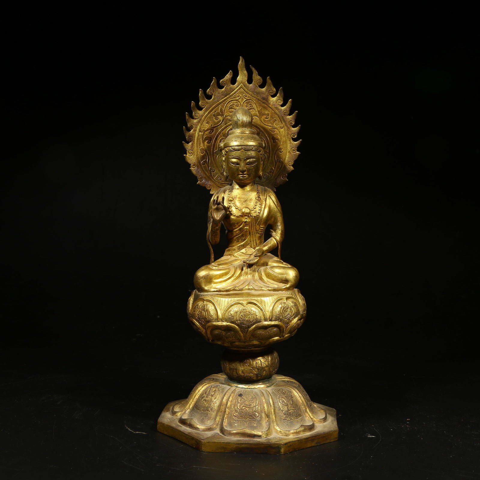 A GILT-BRONZE FIGURE OF SHAKYAMUNI BUDDHA: Gilt-Bronze Figure of Shakyamuni Buddha