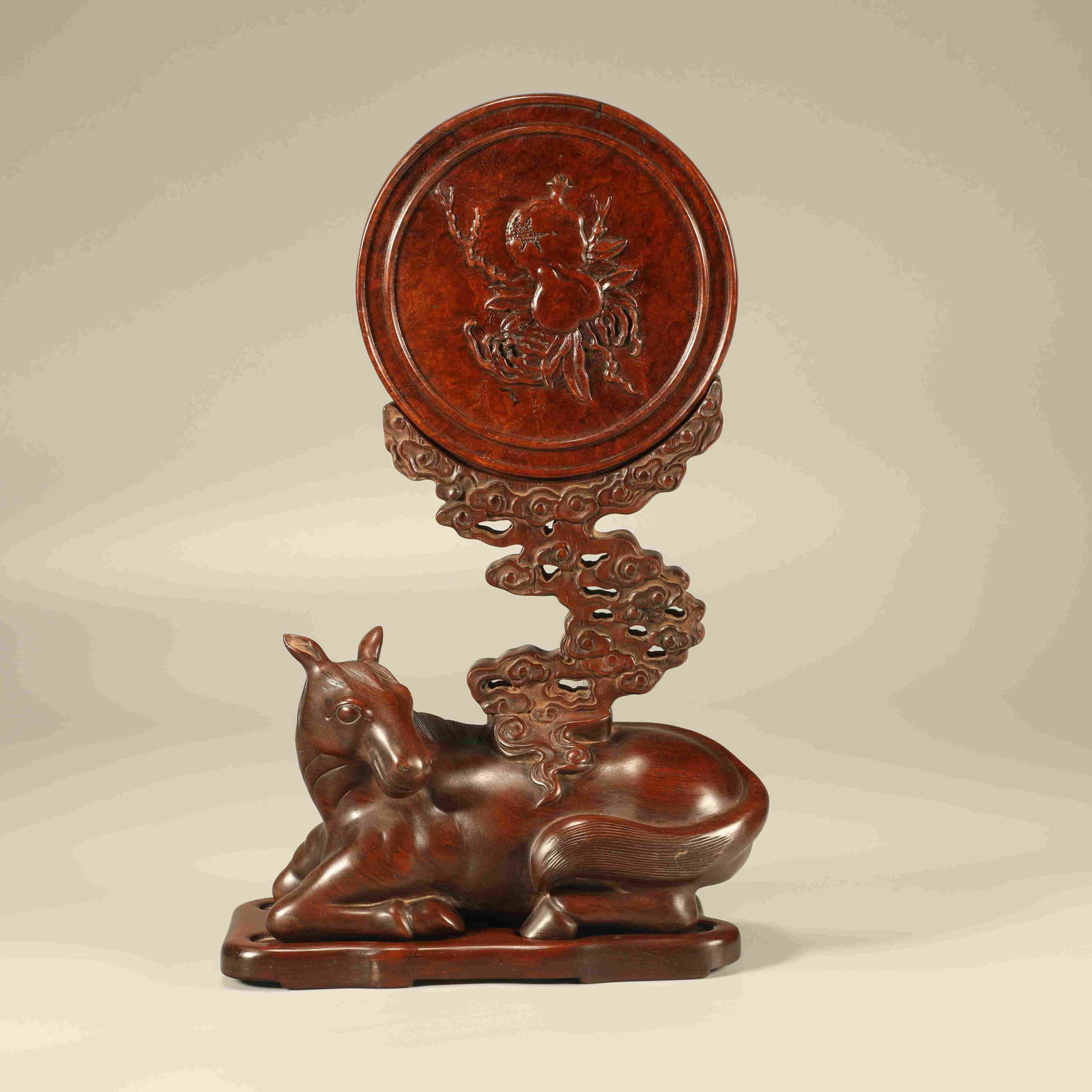 A HUANGHUALI CARVED RECUMBENT HORSE "THREE ABUNDANCES" ORNAMENT: Huanghuali Carved Recumbent Horse "Three Abundances" Ornament
