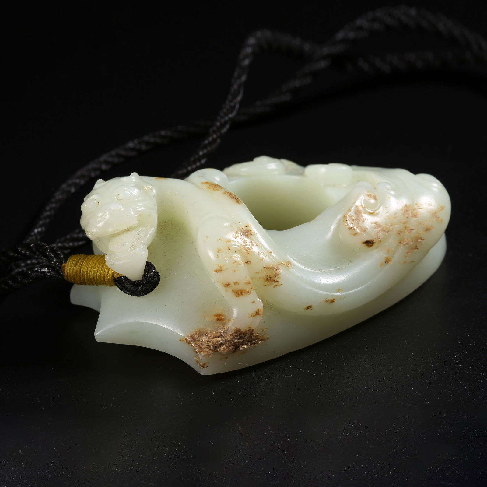 A ARCHAIC JADE "CHICKEN-HEART" PENDANT: Archaic jade "chicken-heart" pendant