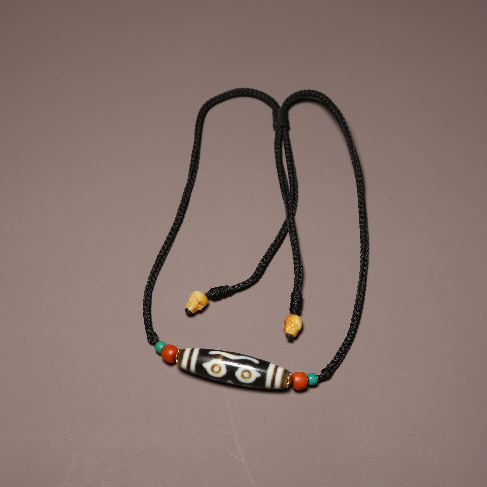 A STRAND OF AGATE DZI BEAD (1 of 9)