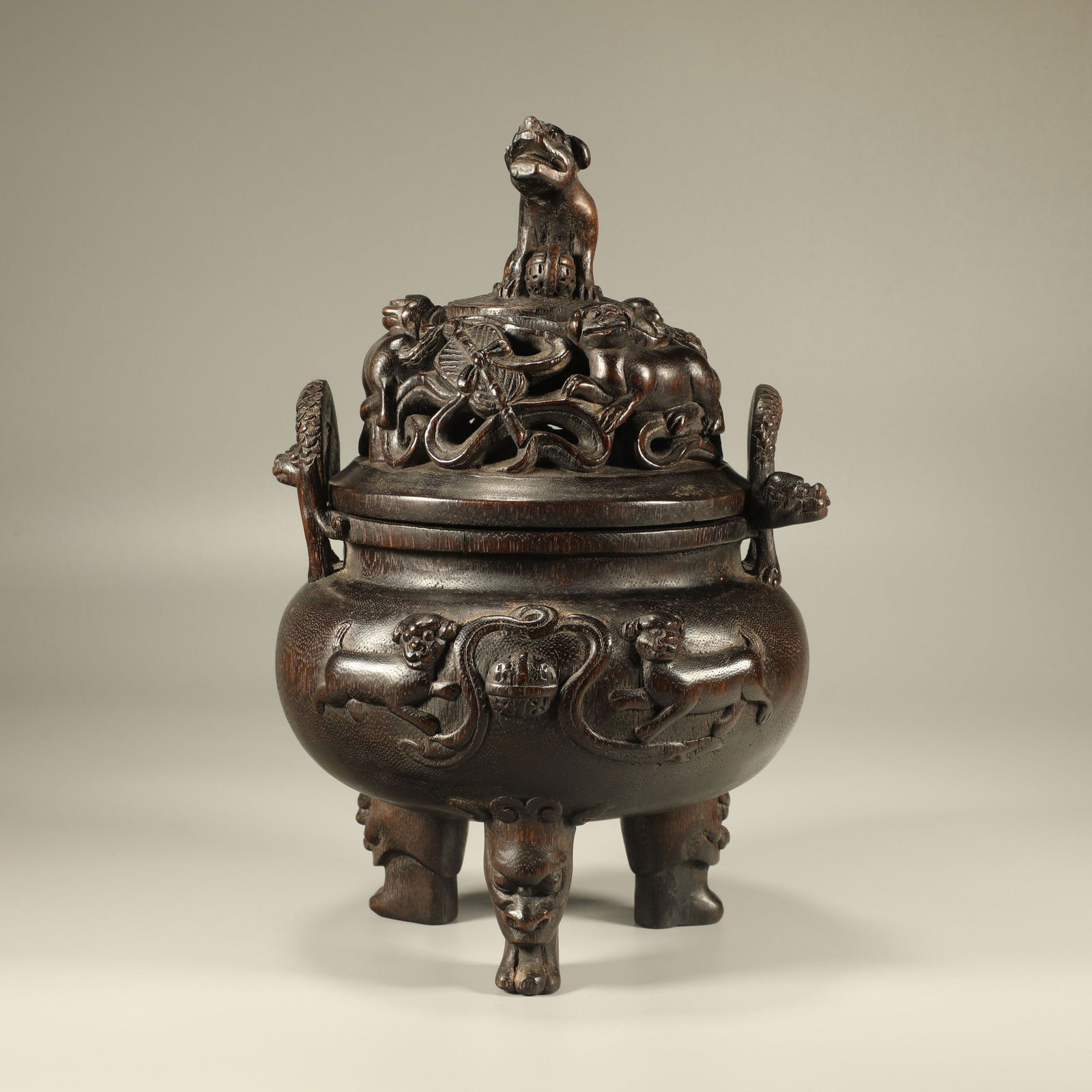 A AGARWOOD CARVED LION PLAYING WITH BALL INCENSE BURNER: Agarwood Carved Lion Playing with Ball Incense Burner