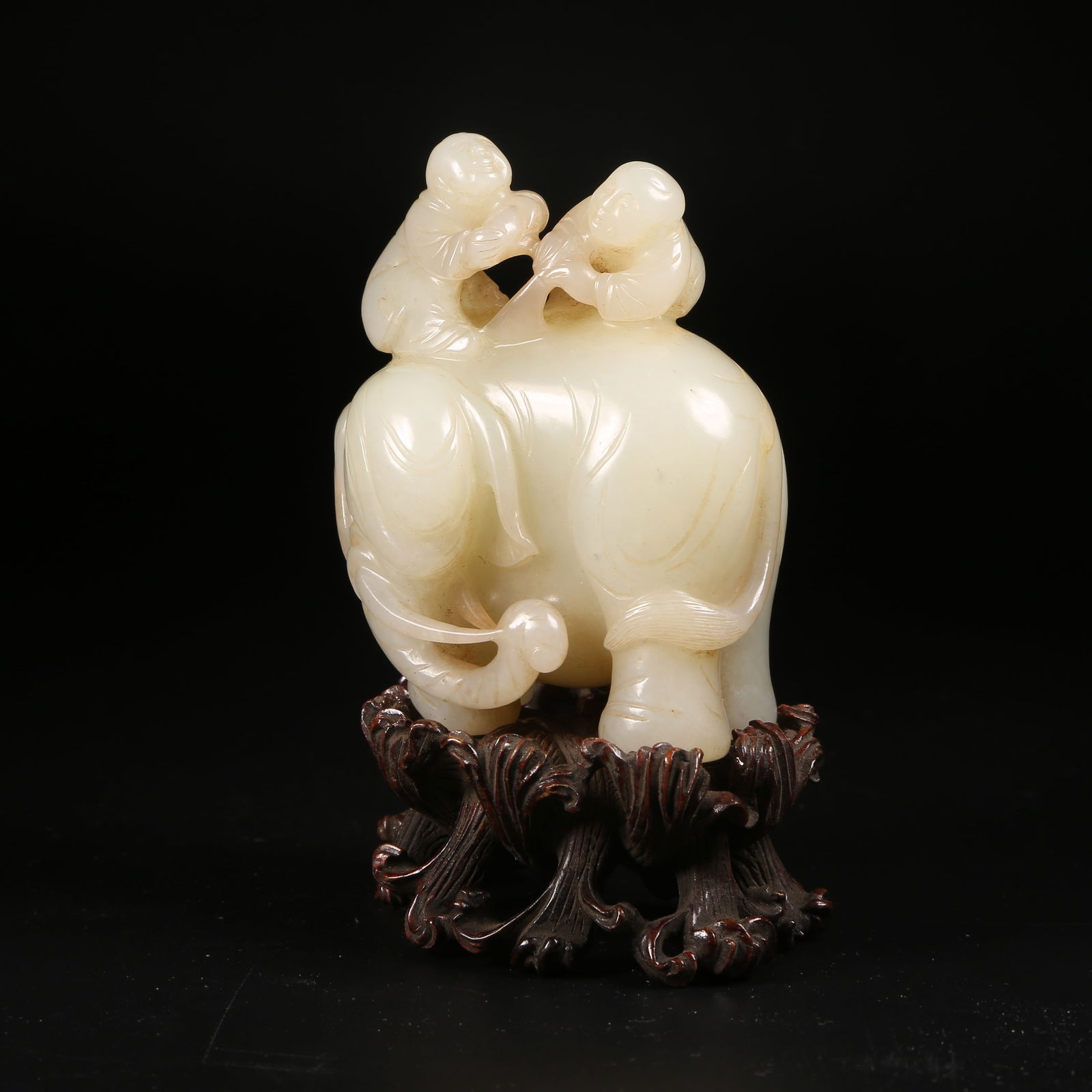 A HETIAN JADE ORNAMENT OF A CHILD PLAYING WITH AN ELEPHANT (1 of 8)