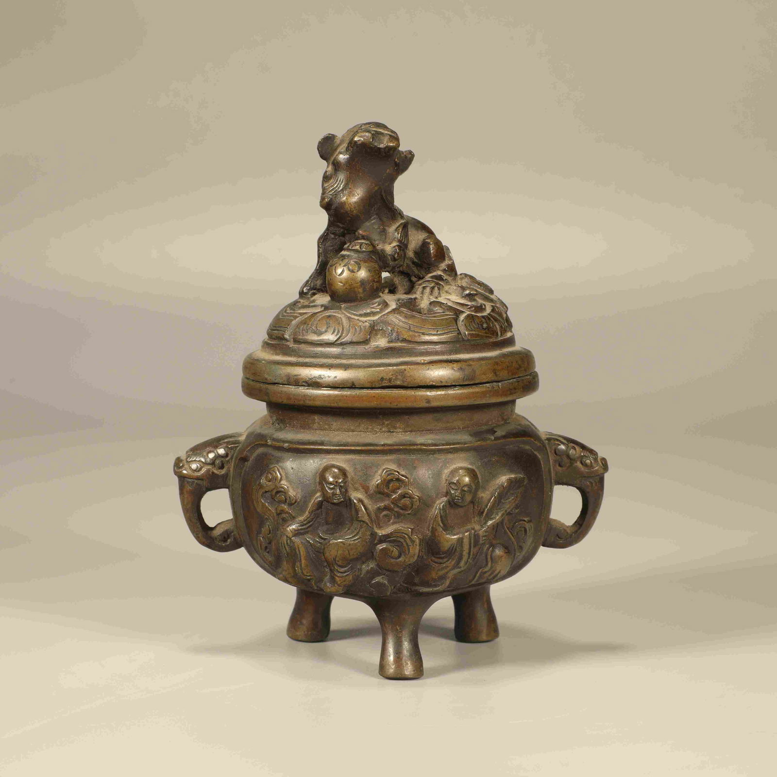 A BRONZE LION-HANDLED ARHAT FIGURE INCENSE BURNER (1 of 6)